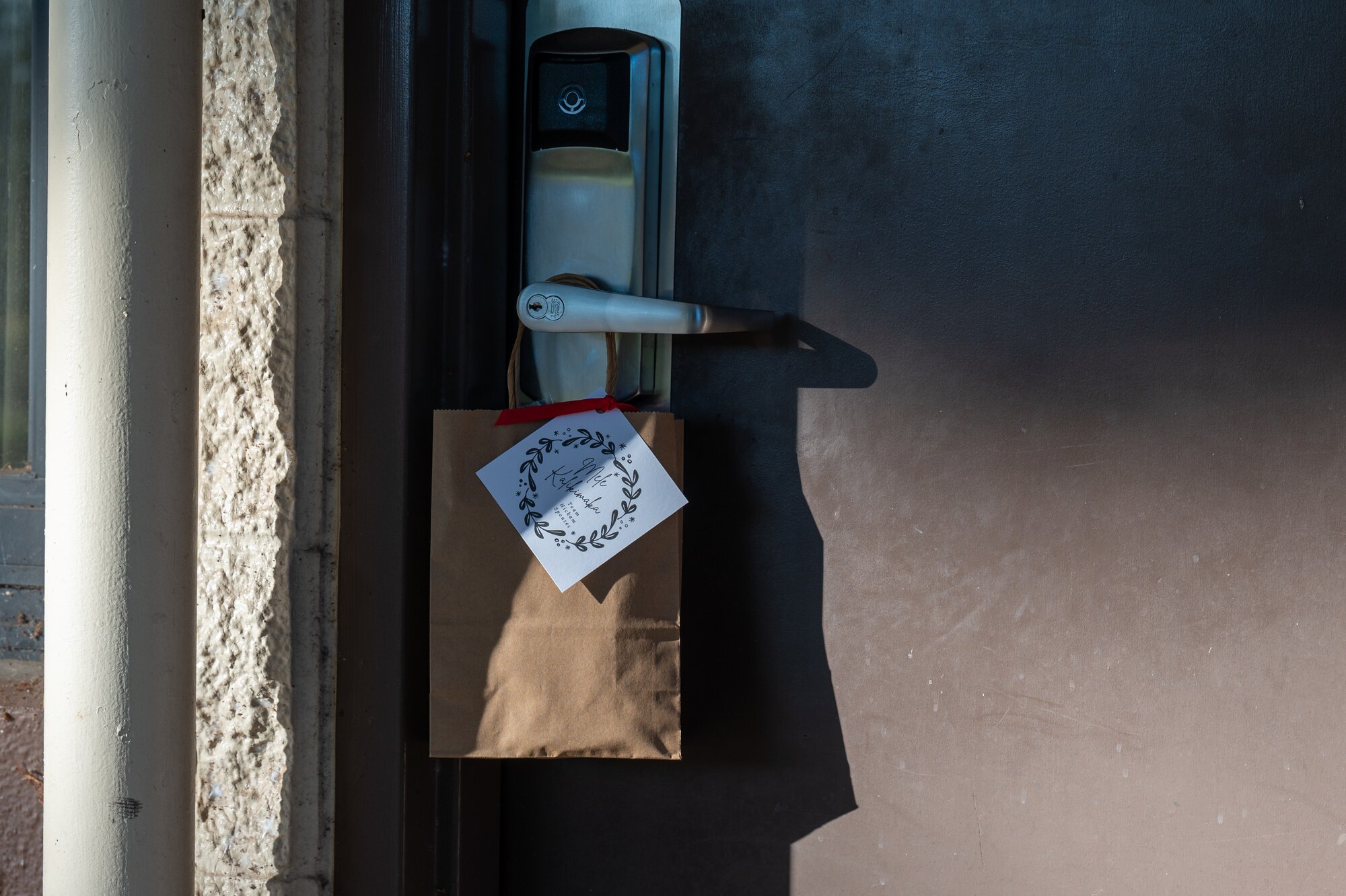 A bag of holiday cookies is left at hanging on the door of an airmen's door by First Sergeants on Joint Base Pearl Harbor-Hickam, Hawaii.