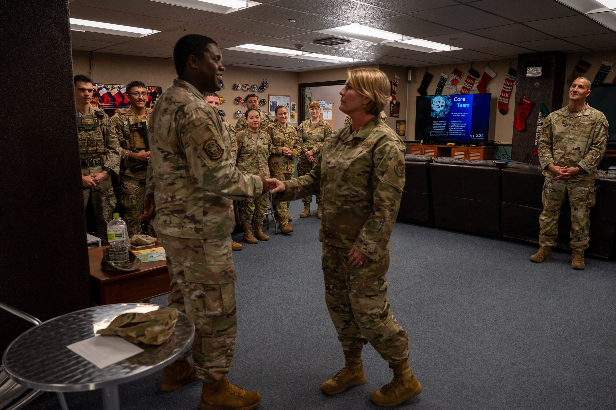 Service member receives coin.