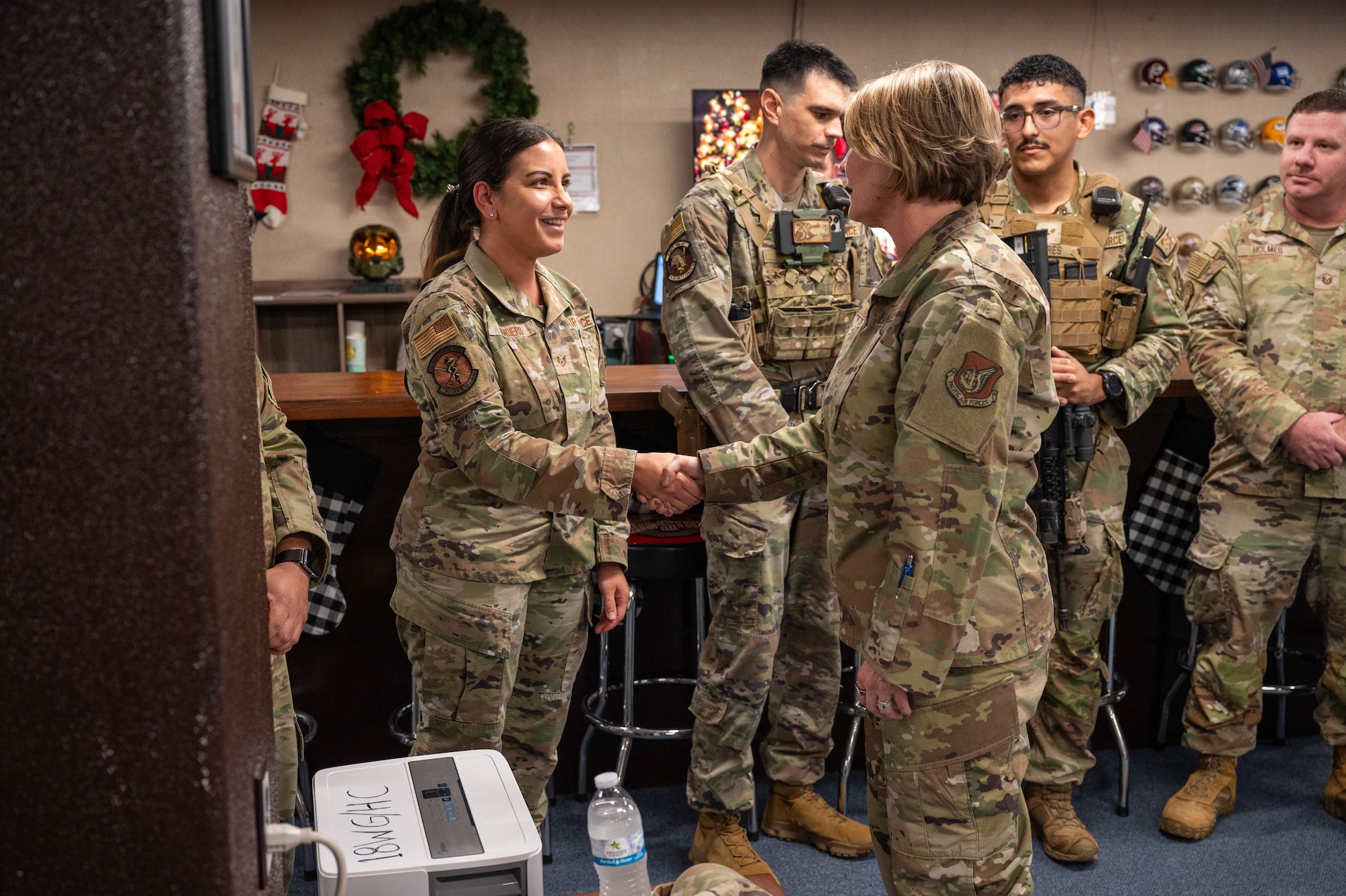 Service member receives coin.