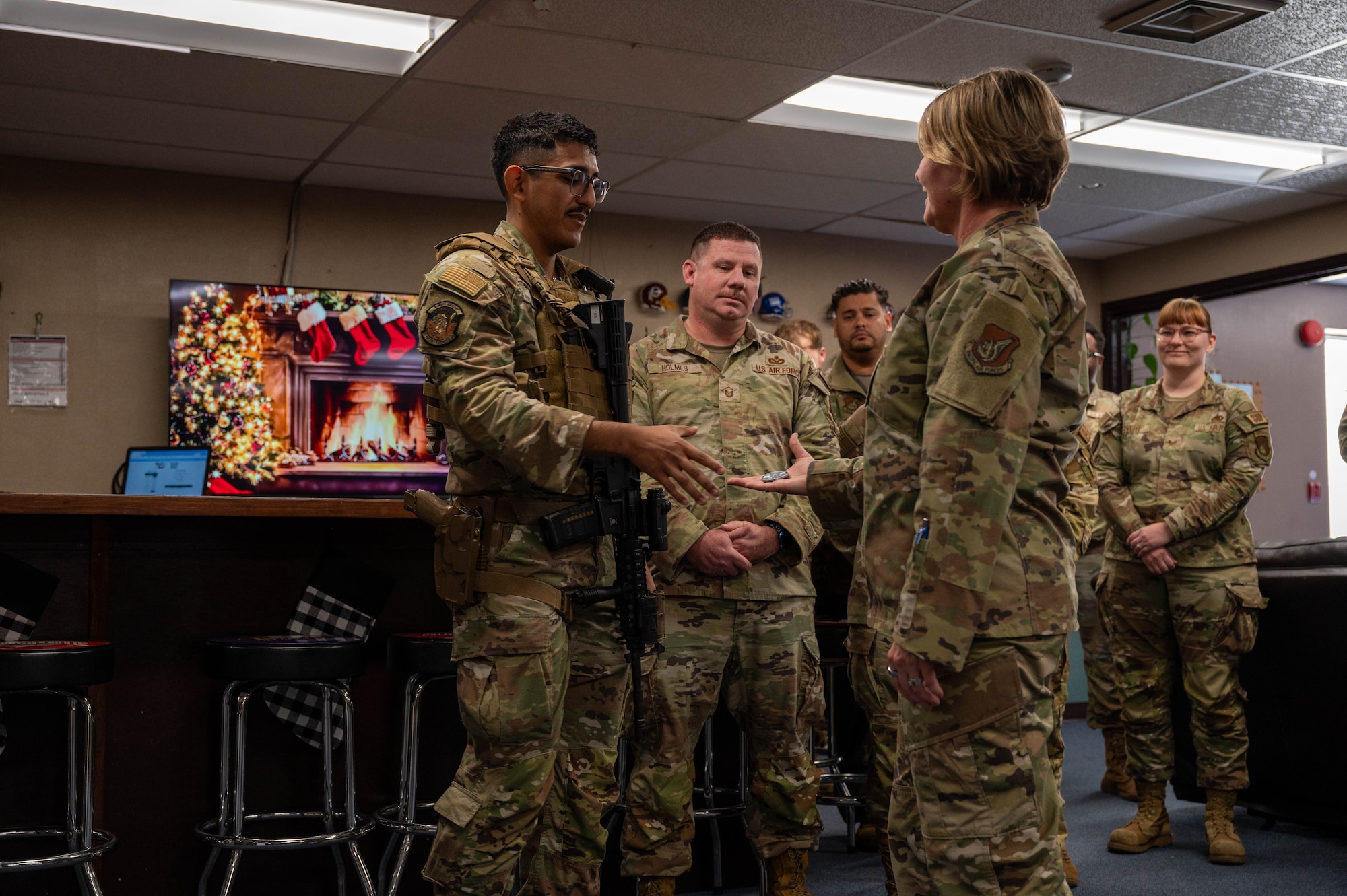 Service member receives coin.