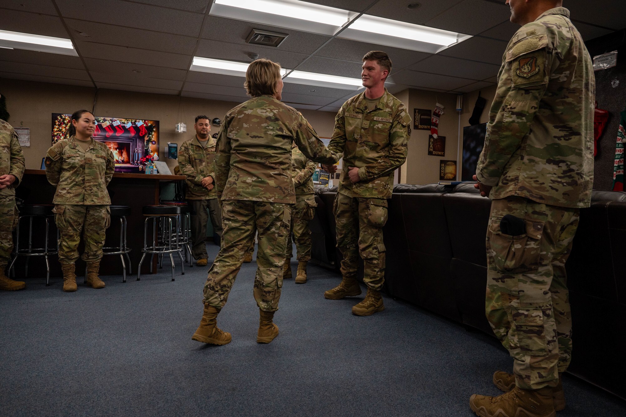 Service member receives coin.