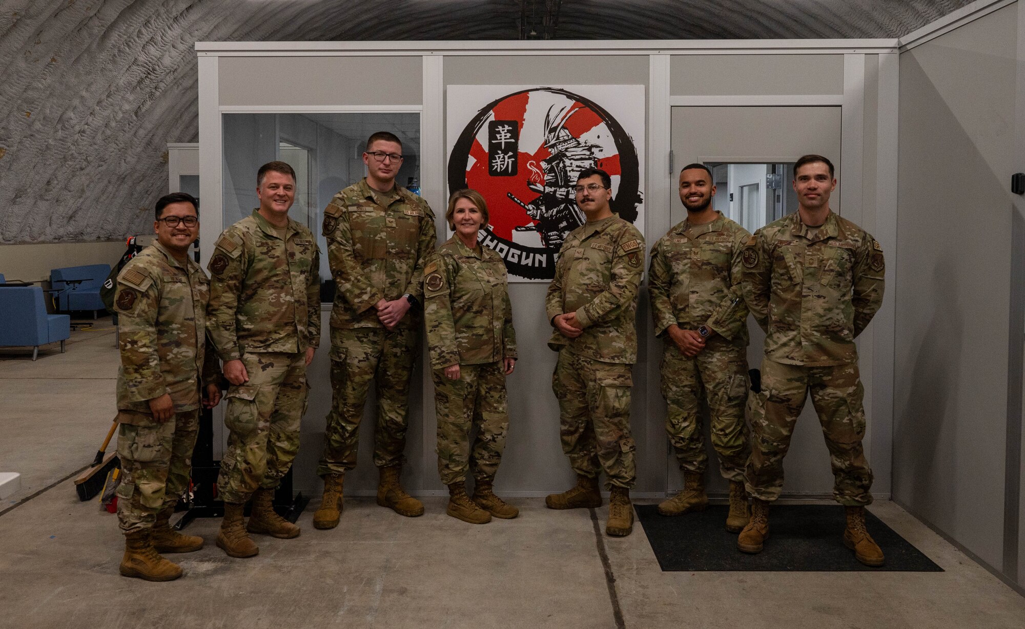 Service members pose for a photo.