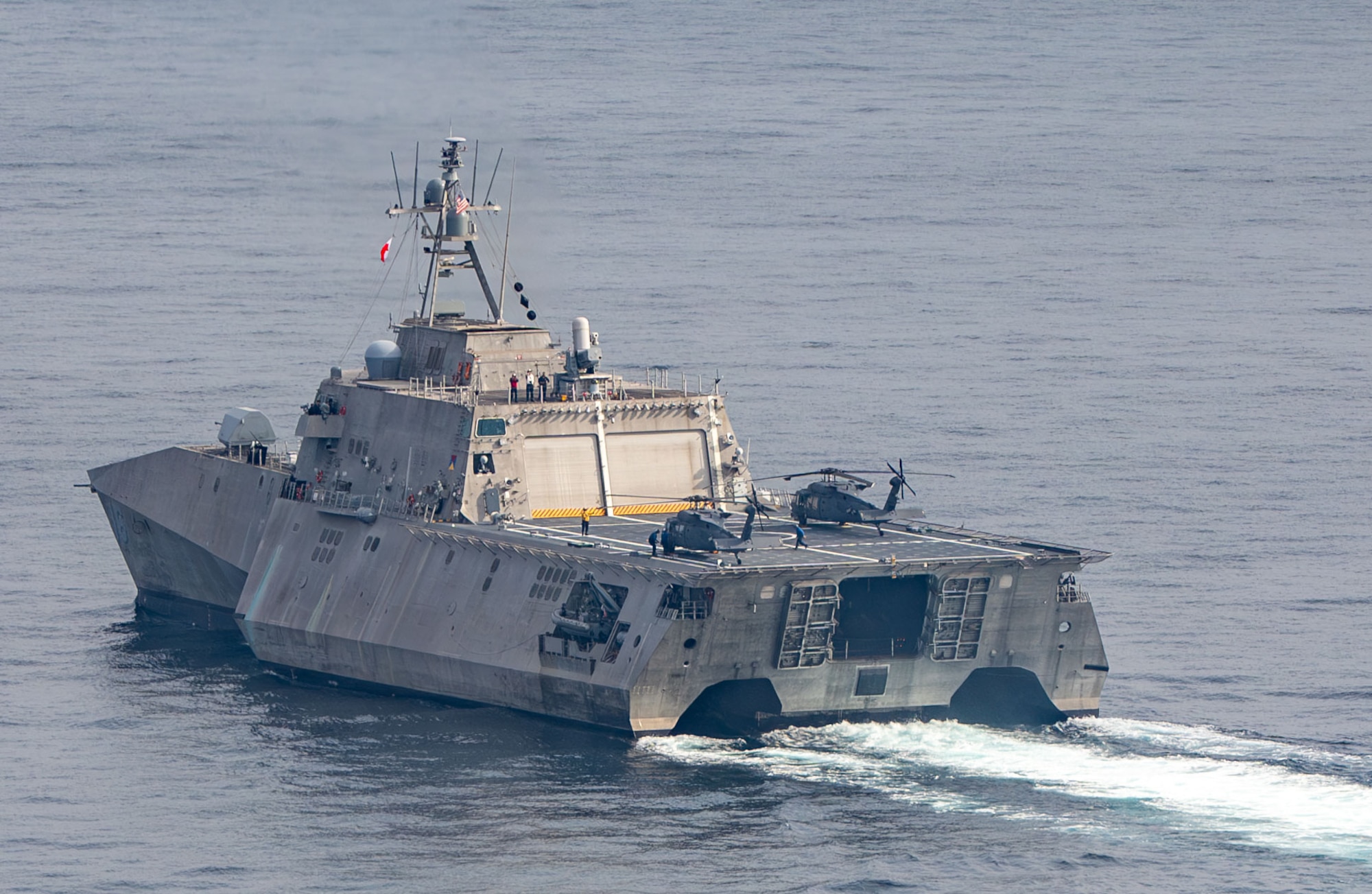 U.S Air Force HH-60W Jolly Green II helicopters land on littoral combat ship USS Tulsa (LCS 16)