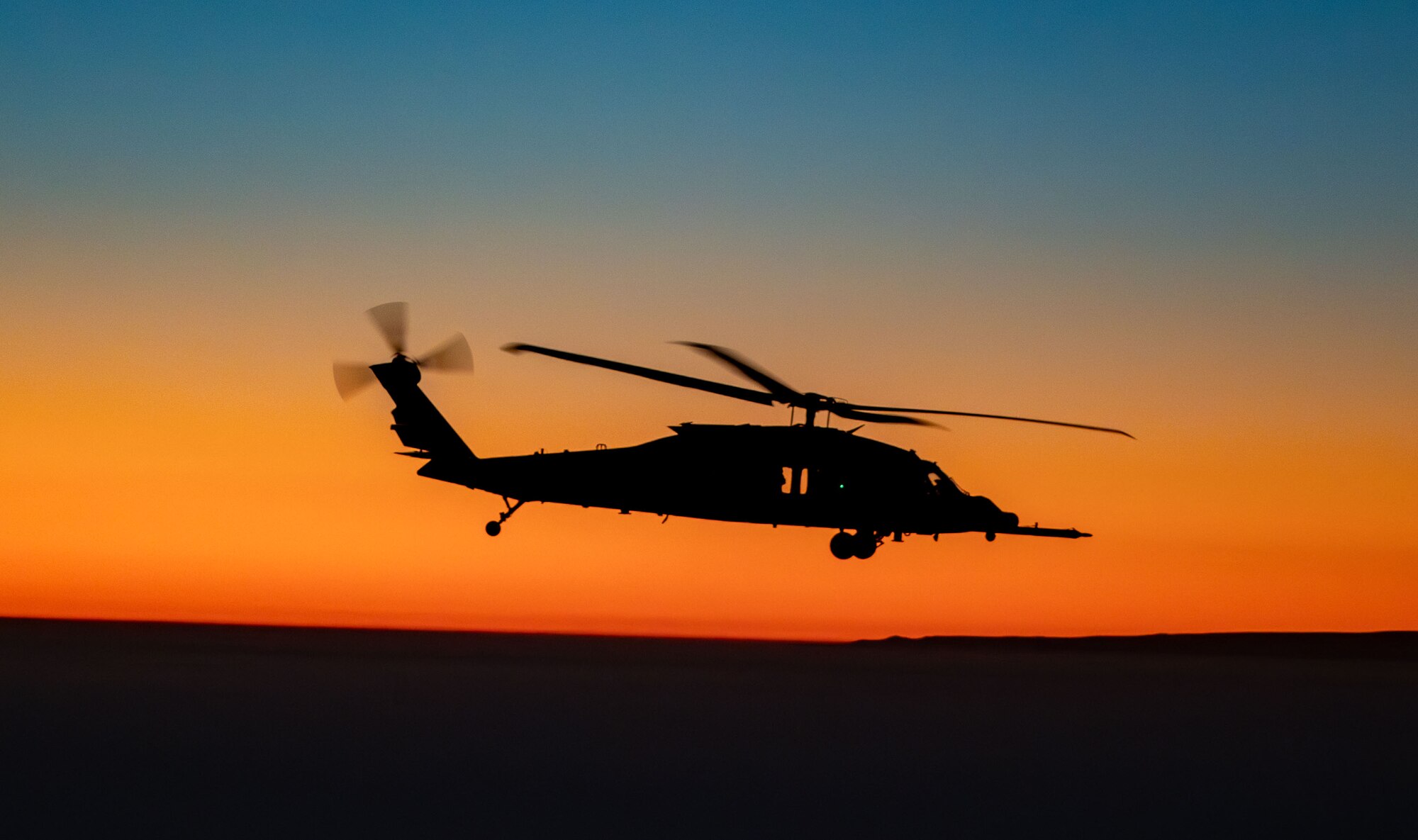 A U.S. Air Force HH-60W Jolly Green II helicopter flies off the coast of California