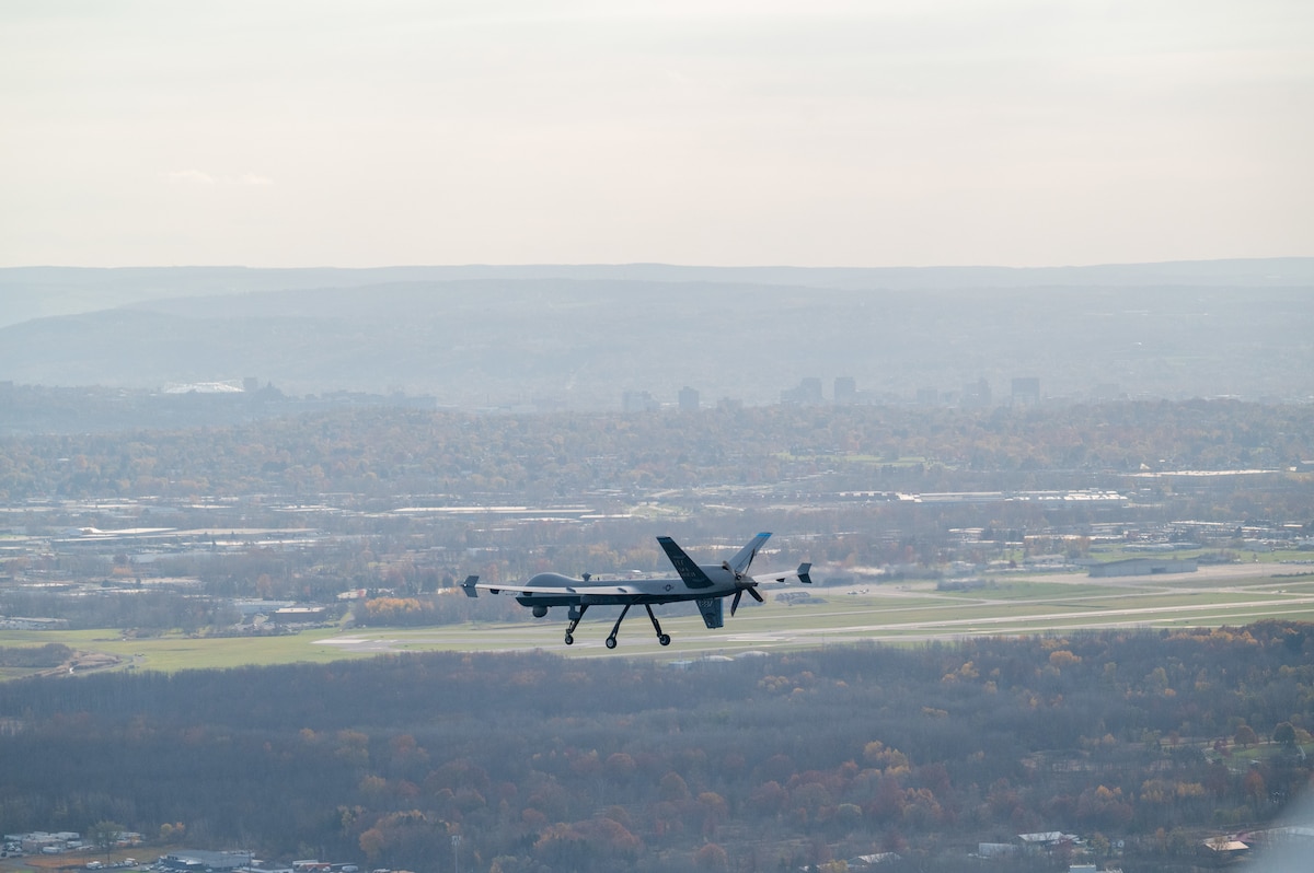 A MQ-9 Reaper assigned to the 174th Attack Wing flies over Hancock Field Air National Guard Base, Syracuse, NY, during a routine training flight, Oct. 31, 2024. The 108th Attack Squadron conducts training flights to instruct pilots and sensor operators on proper operations of the aircraft. (U.S. Air National Guard photo by Senior Airman Dylan McCrink)
