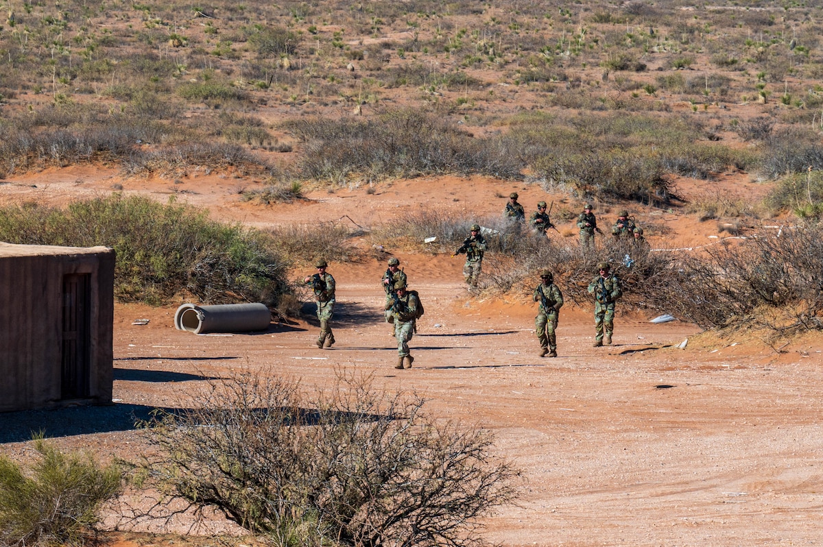 U.S. Air Force security forces Defenders assigned to the 13th Combat Air Base Squadron assault a simulated village during the 13th CABS first Air Task Force training event, Dec. 14, 2024, at Camp McGregor, New Mexico.