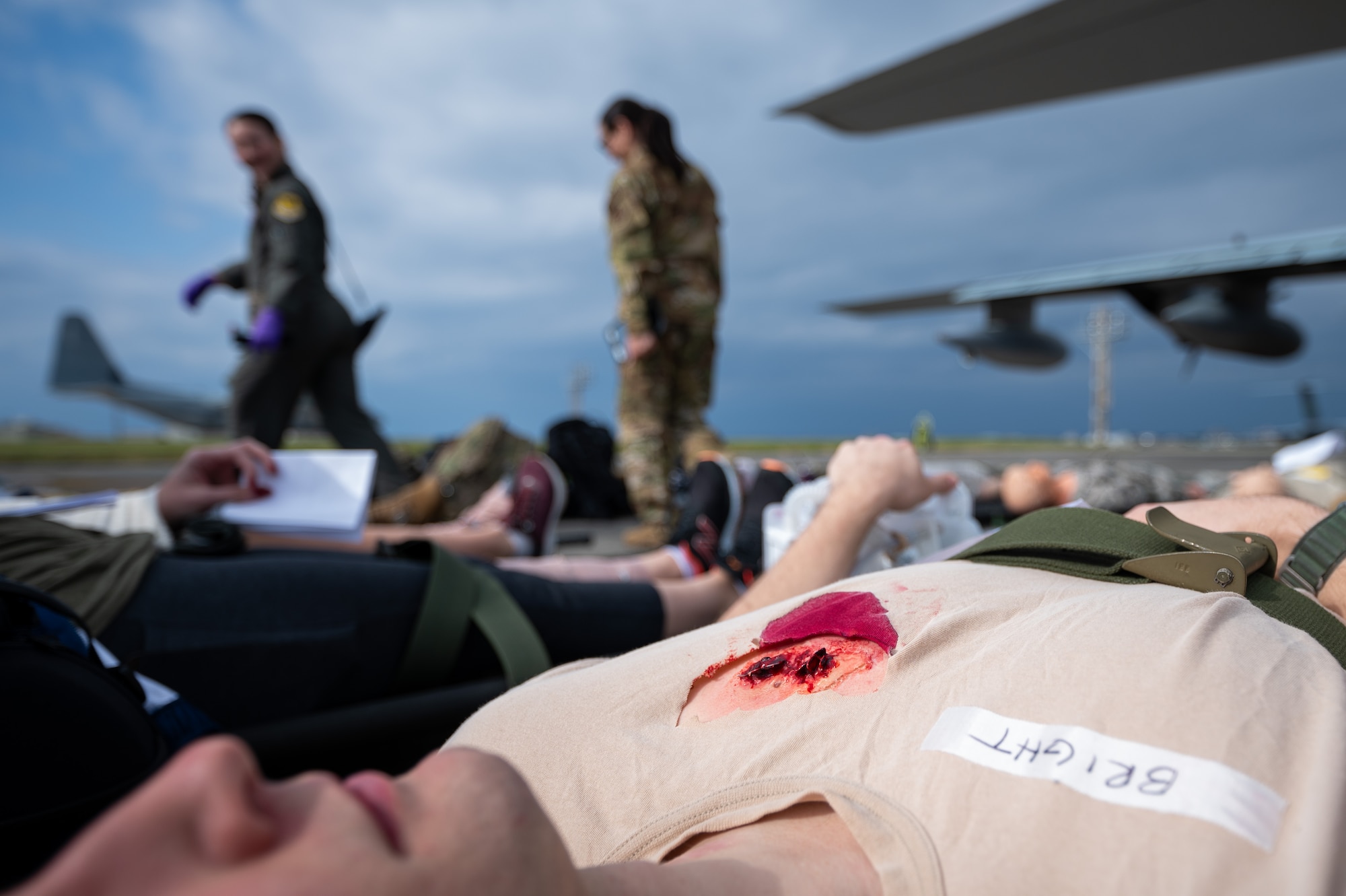 U.S. Air Force Airmen with the 18th Aeromedical Evacuation Squadron conduct a scenario for identifying simulated patients’ injuries during a patient transfer exercise with the Marine Aerial Refueler Transport Squadron 152 at Kadena Air Base, Japan, Dec. 18, 2024.