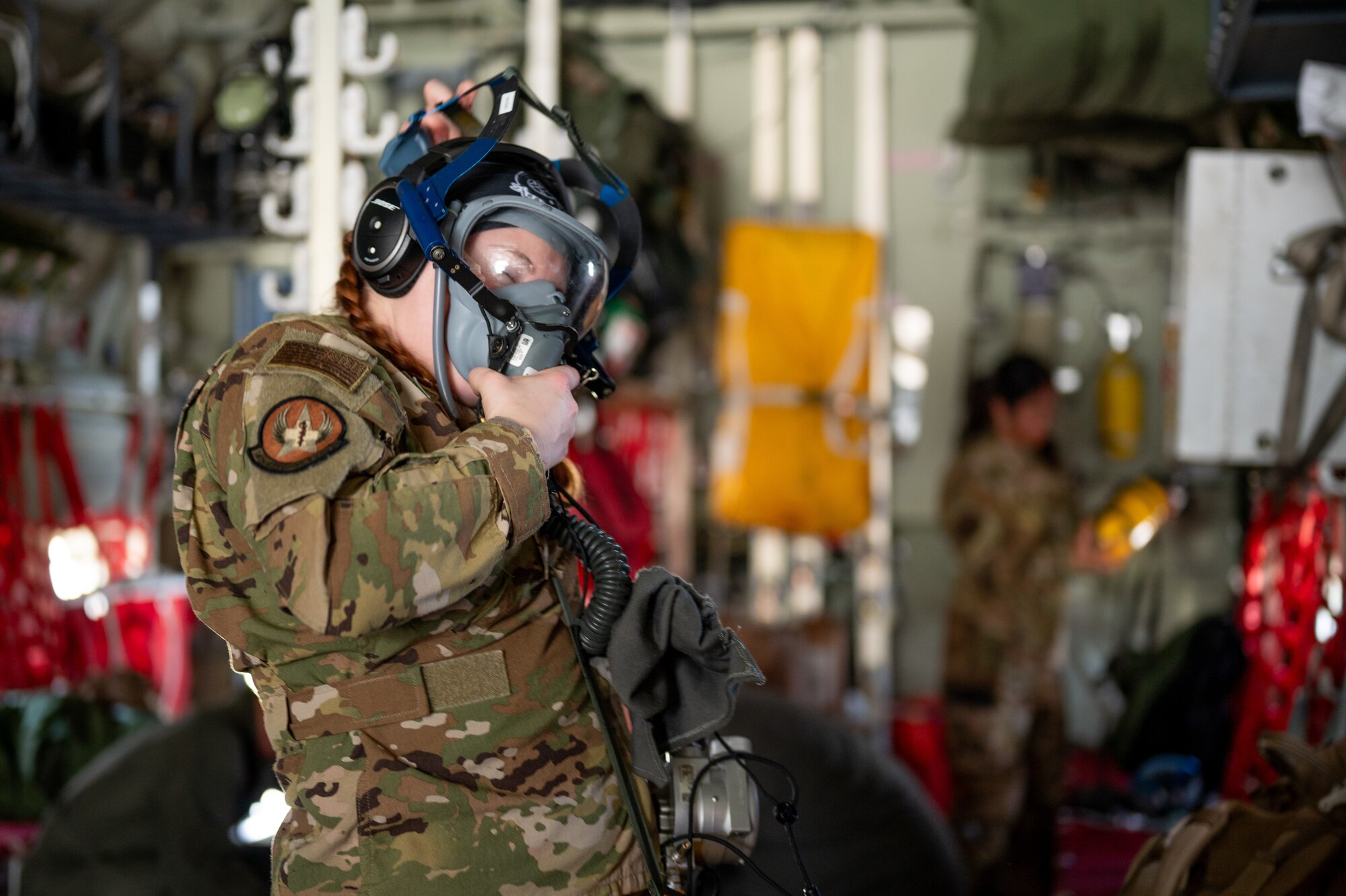 U.S. Air Force Capt. Dreannen McConnell, 18th Aeromedical Evacuation Squadron flight nurse, tests an oxygen mask before takeoff during a patient transfer exercise with the Marine Aerial Refueler Transport Squadron 152 at Kadena Air Base, Japan, Dec. 18, 2024.