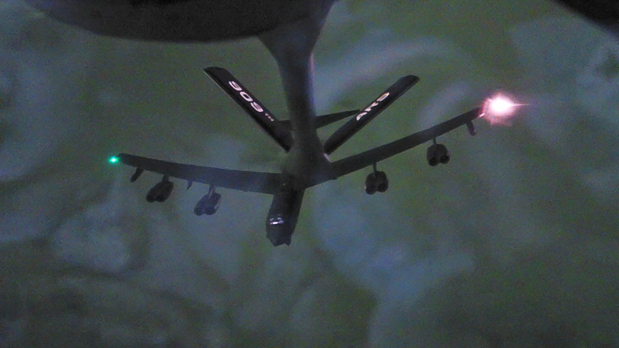 A B-52 disengages from a refueling boom.
