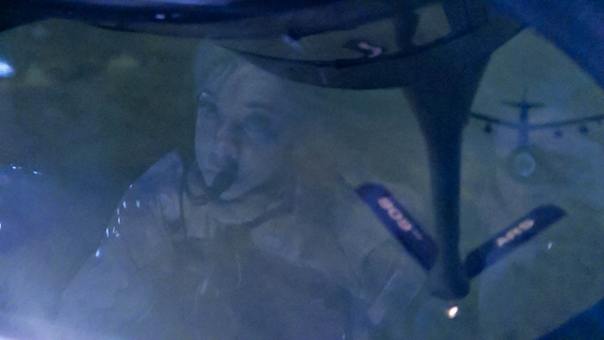 An Airman watches a B-52 approach for aerial refueling.