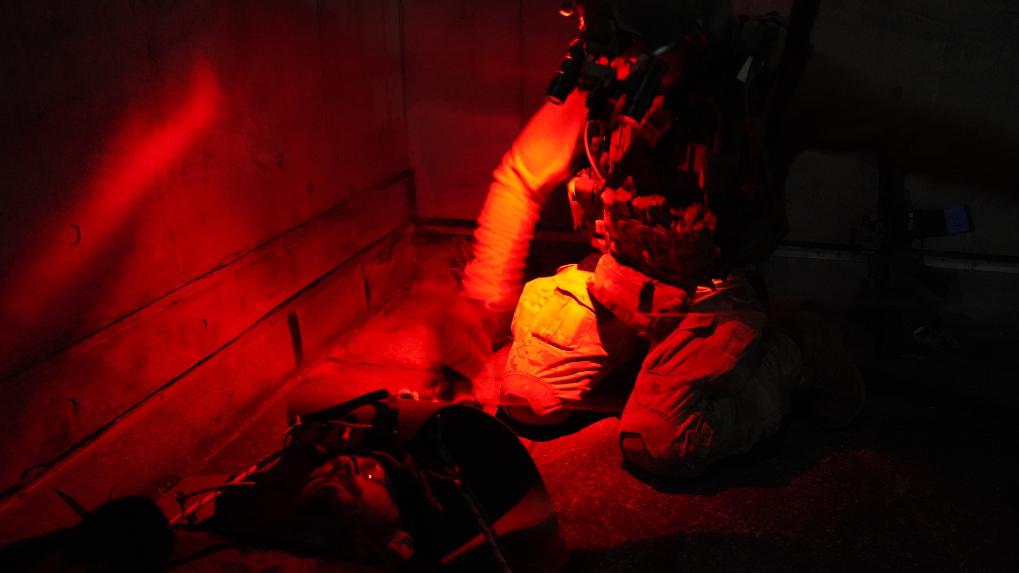 Airman administers aid to a casualty role player.