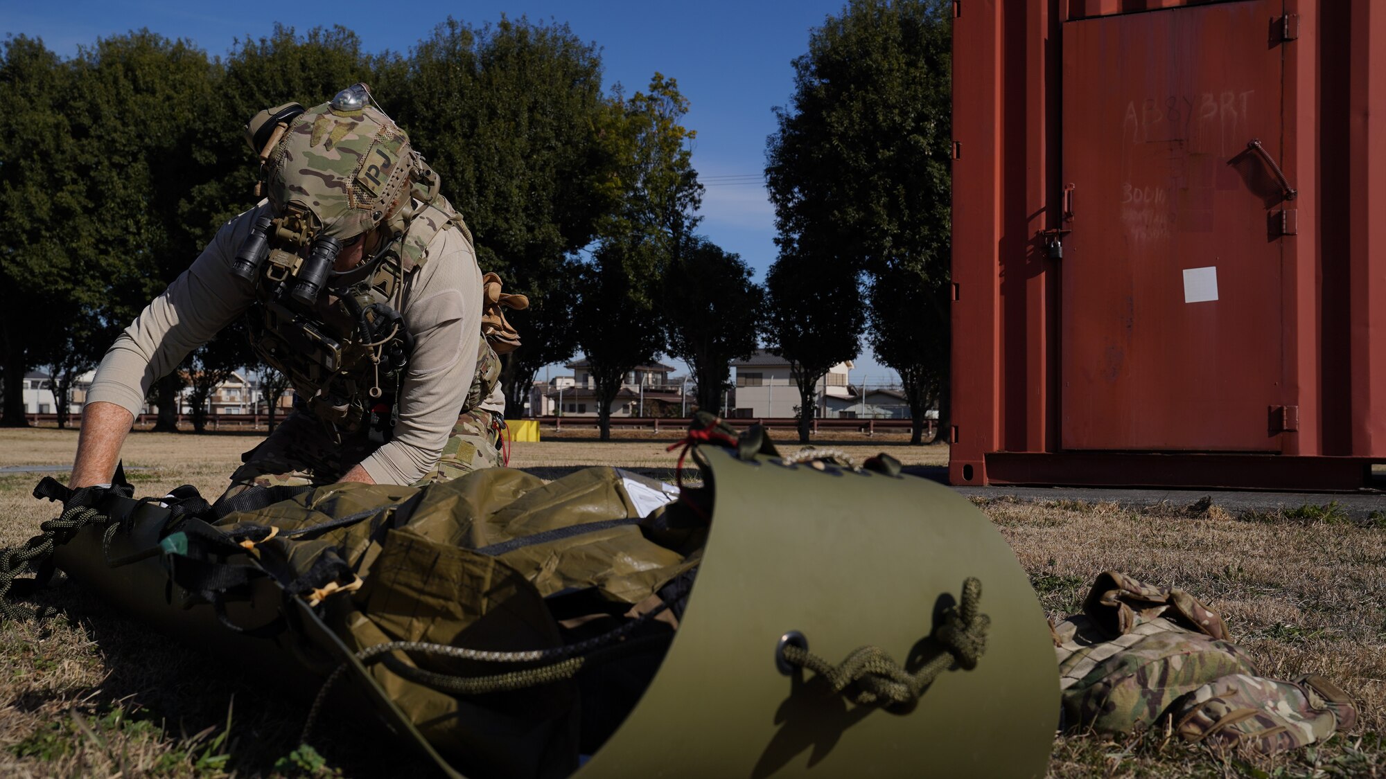 Airman administers aid to a casualty role player.