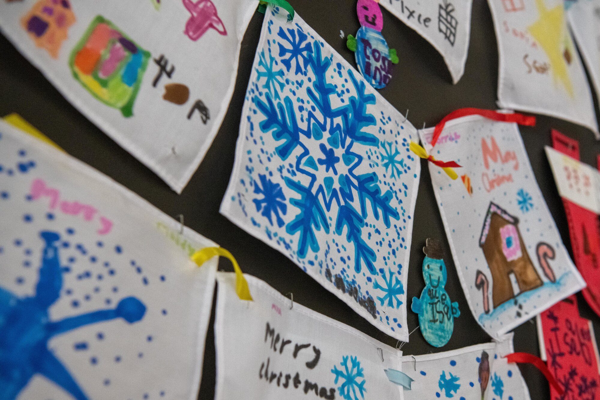 Holiday art is displayed during a visit with Santa Claus
