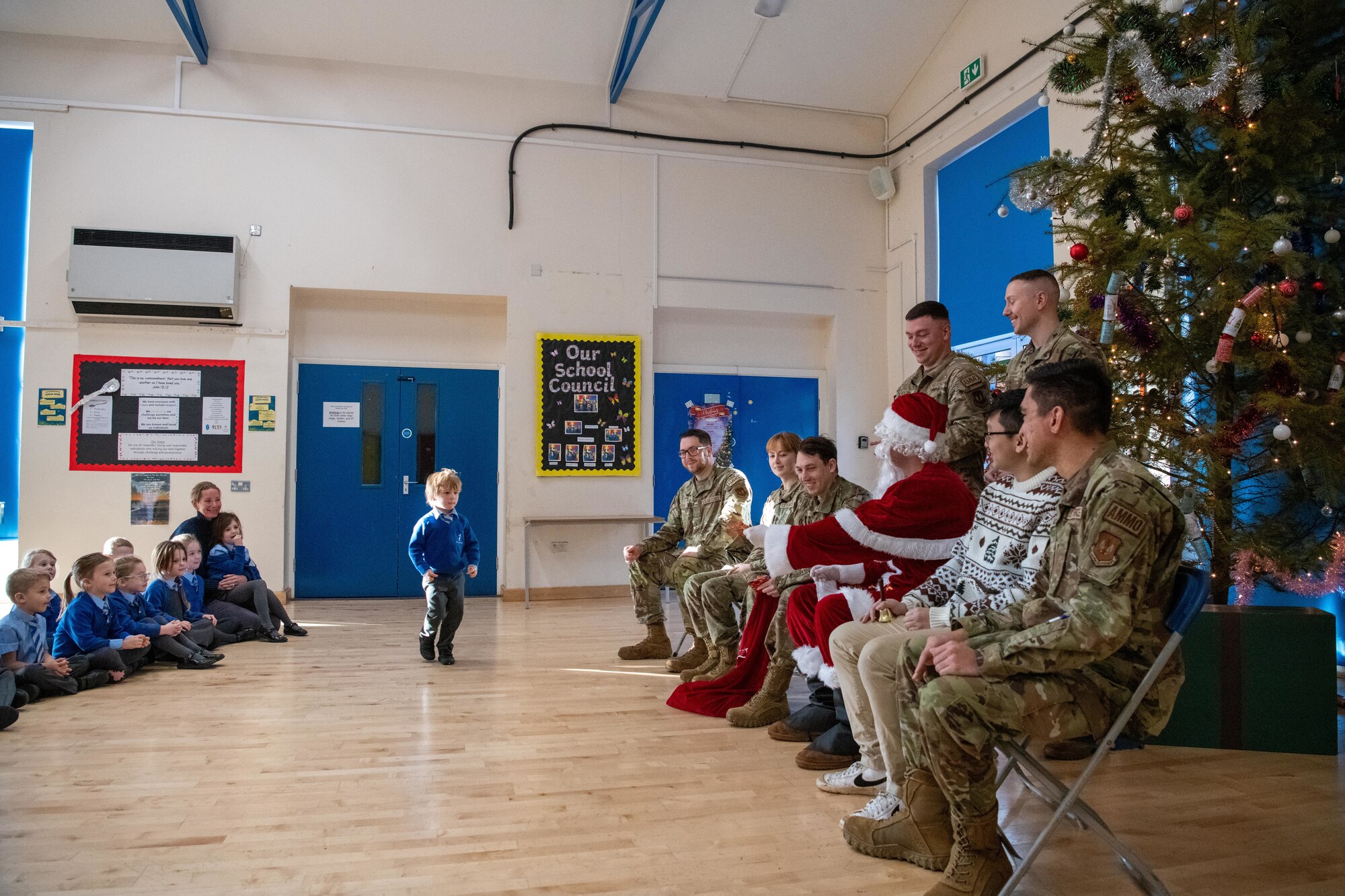 A child prepares to receive a gift from Santa Claus