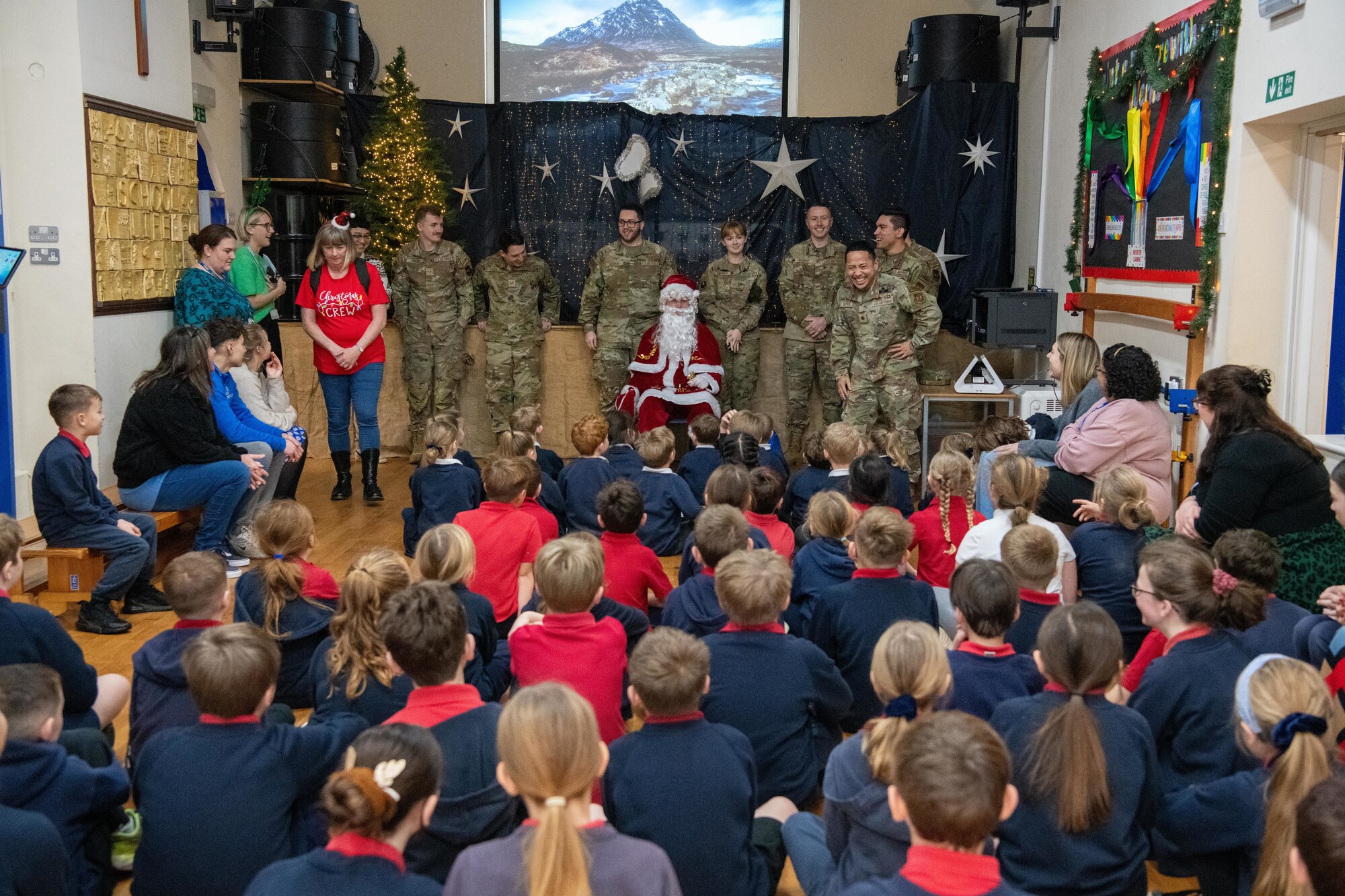 Children speak with Airmen during a visit with Santa Claus