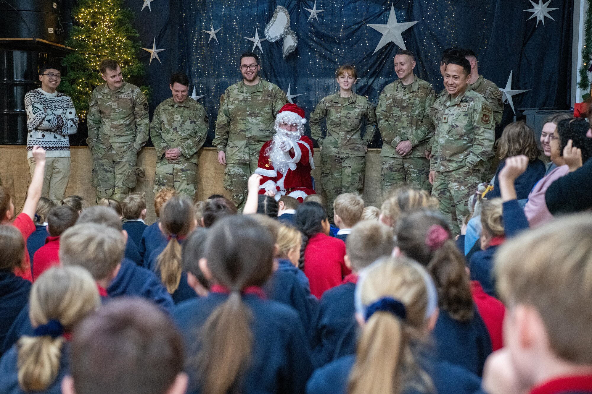 Children speak with Airmen during a visit with Santa Claus