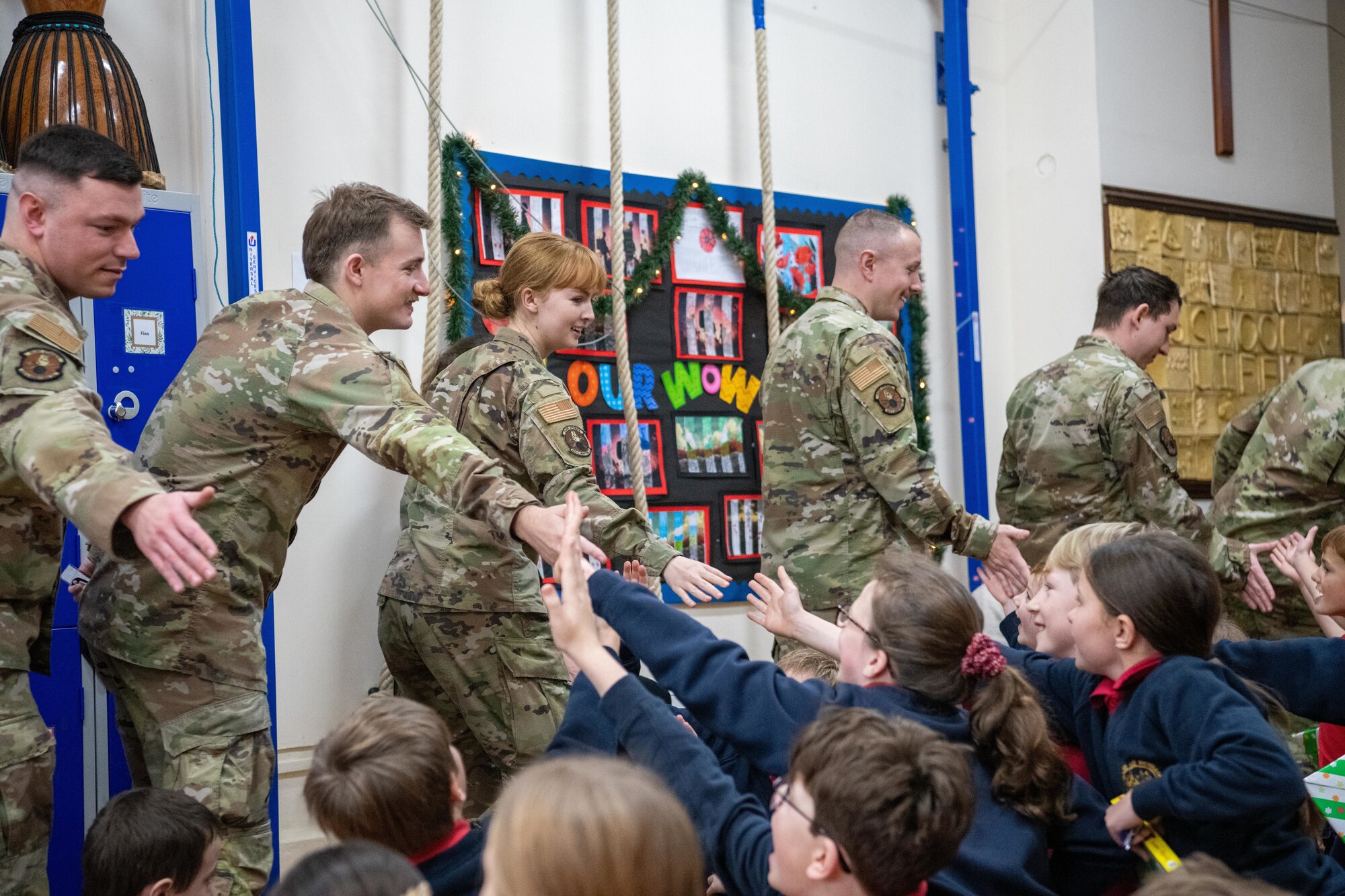 Children high-five Airmen