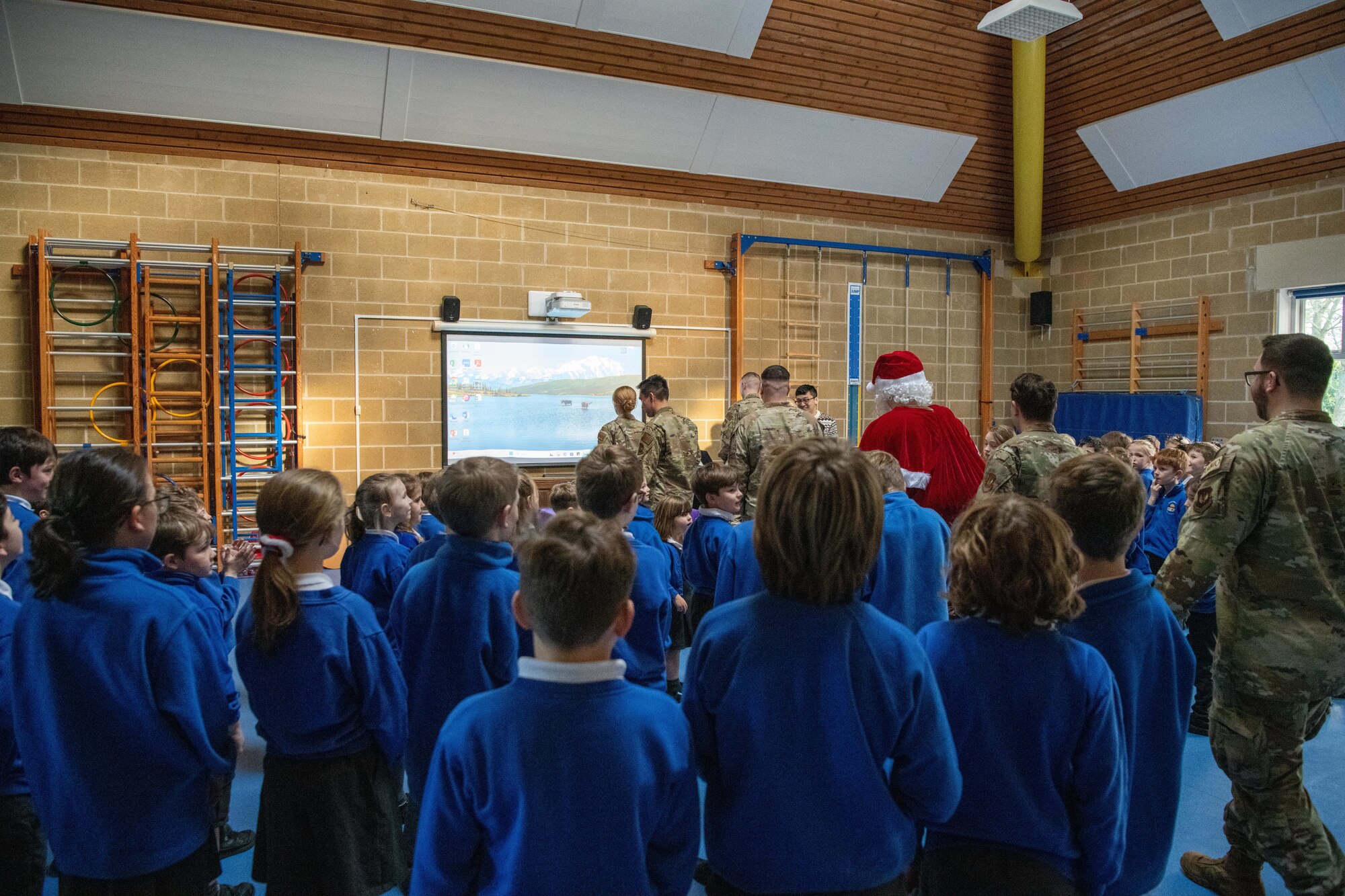 Santa Claus and Airmen visit school children