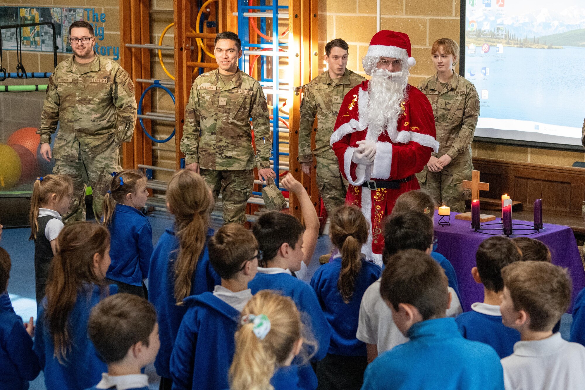 Santa Claus and Airmen visit school children
