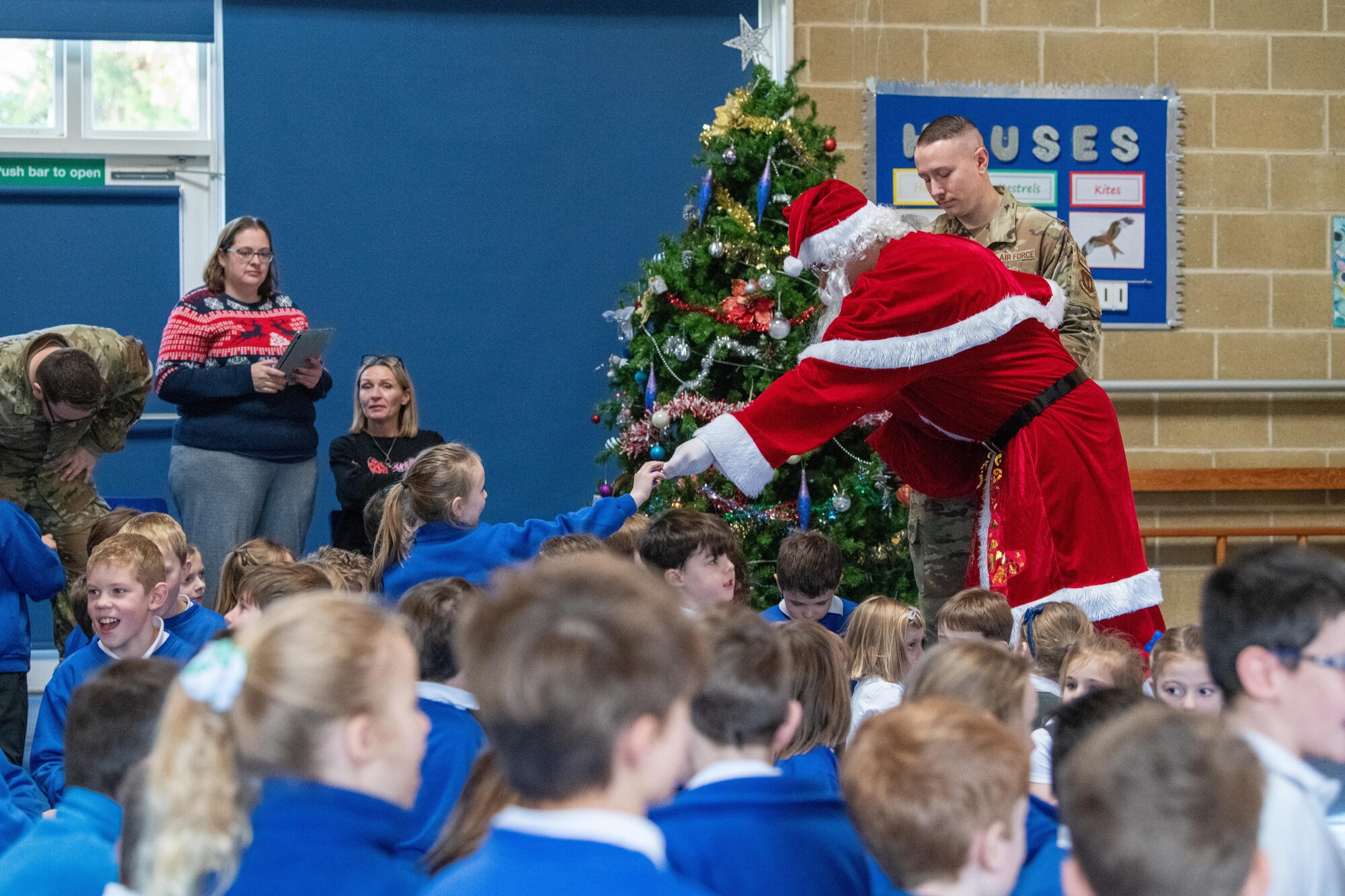 Santa Claus hands sweets to school children
