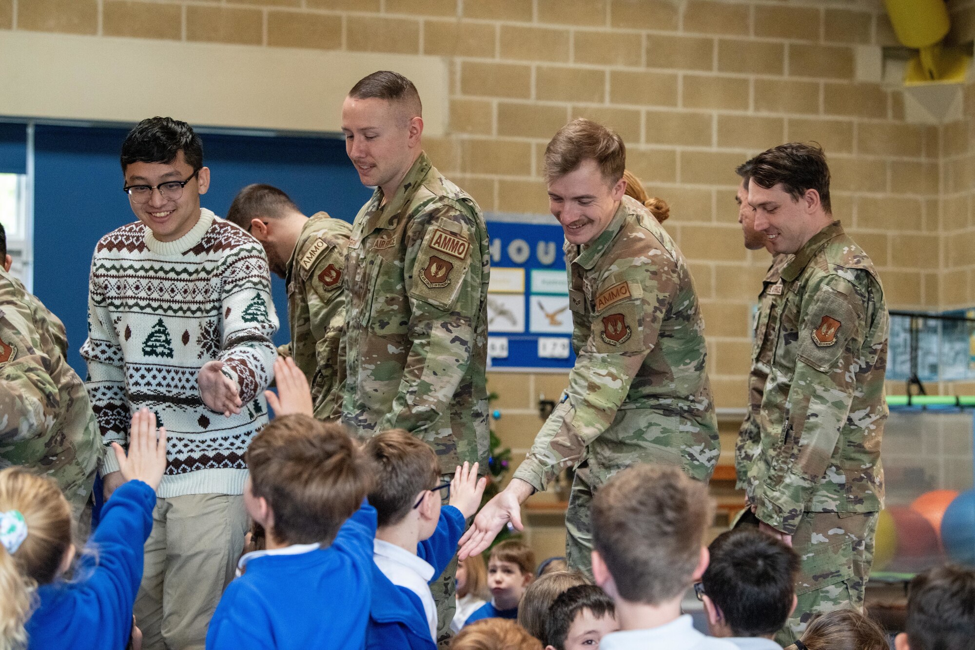 Airmen high-five school children