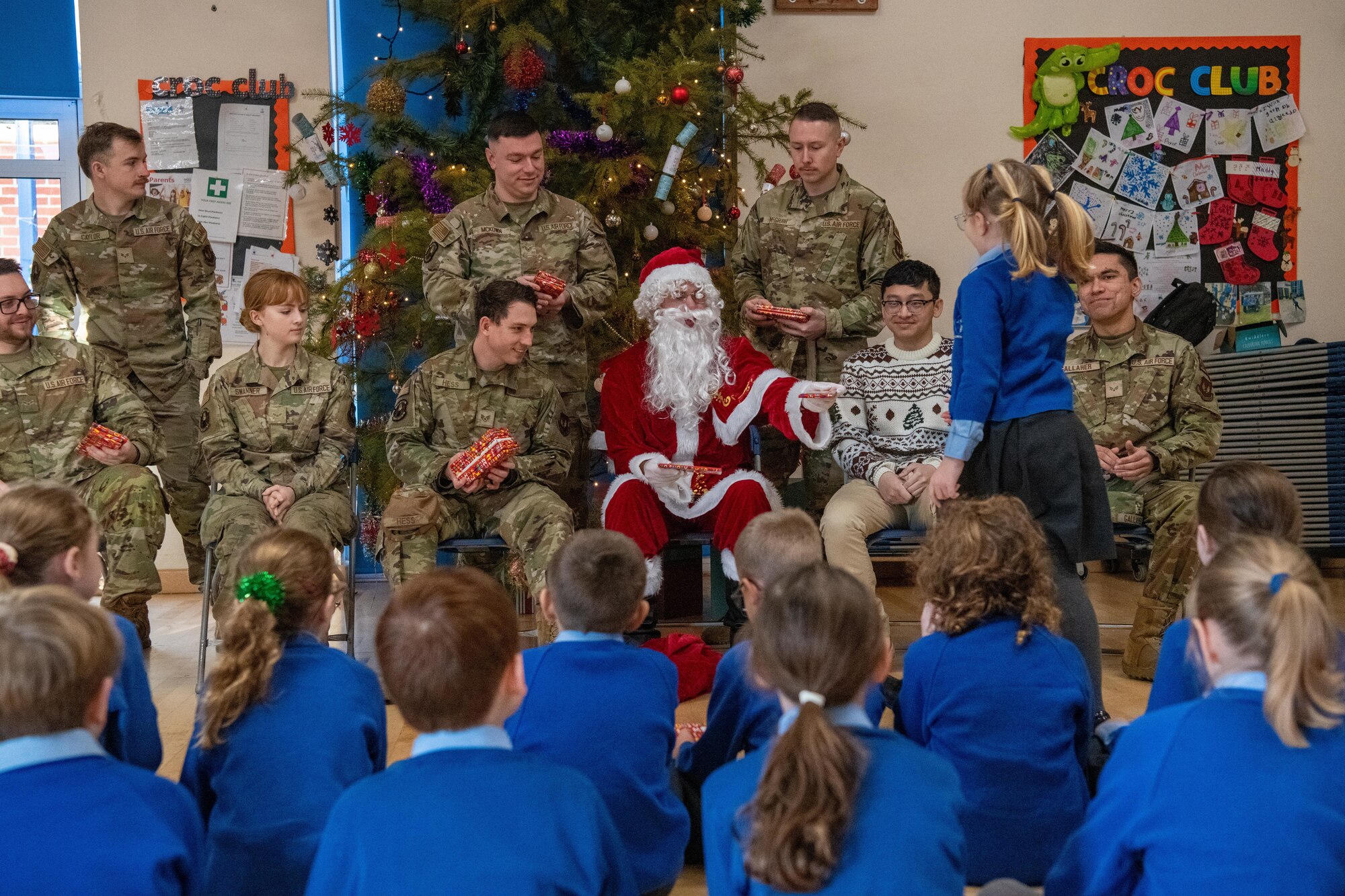 Santa Claus and Airmen visit school children