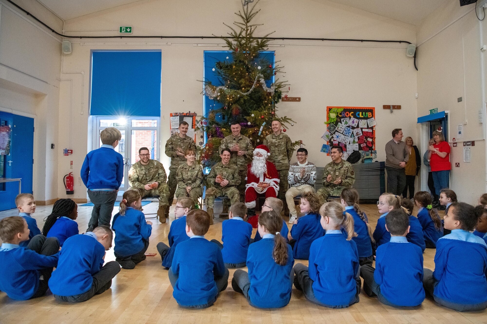 Santa Claus and Airmen visit school children