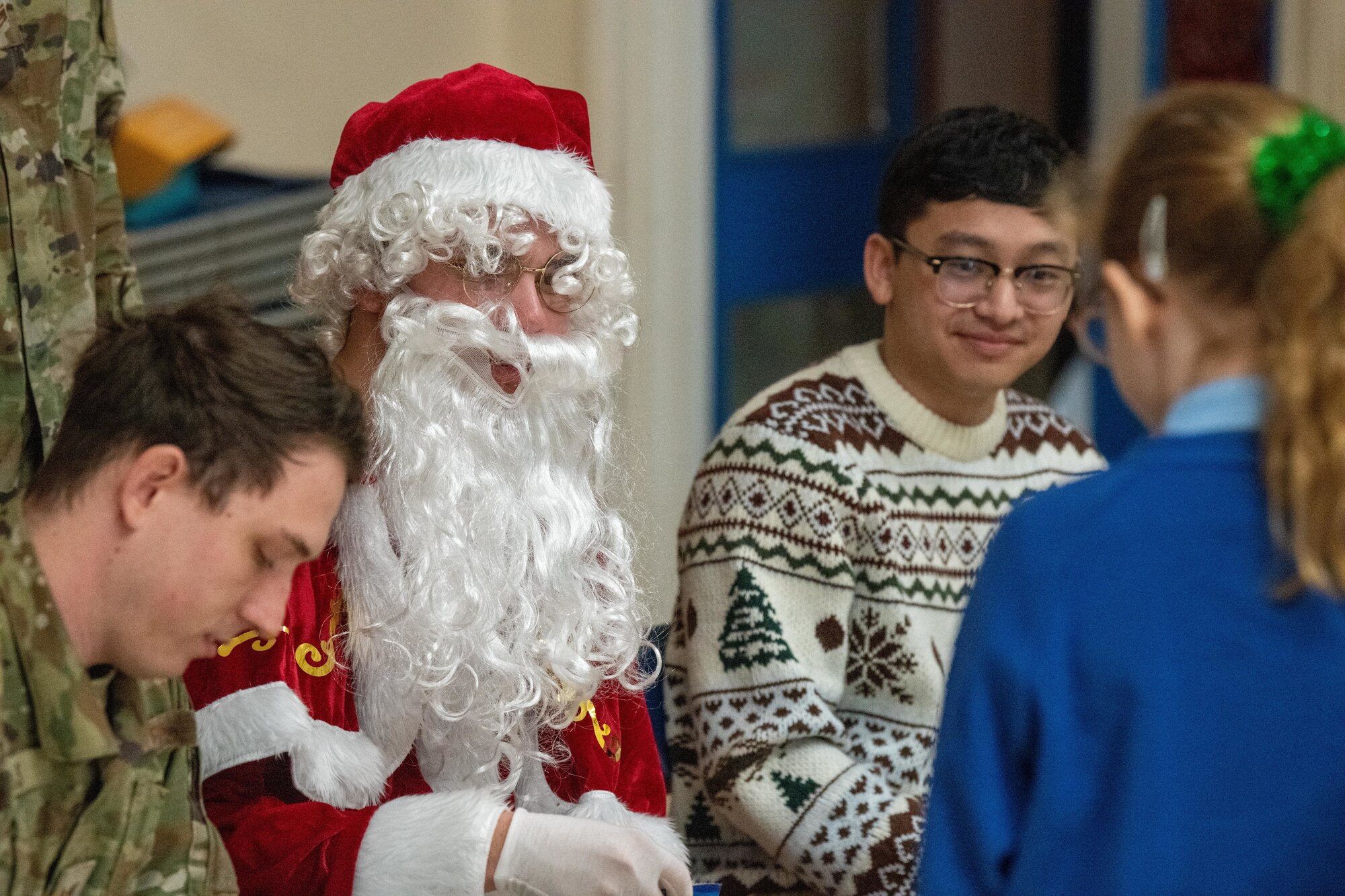 Santa Claus and Airmen visit school children