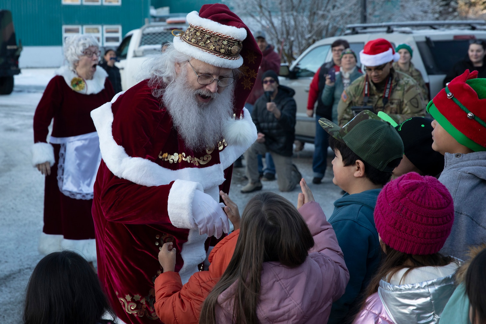 Mr. and Mrs. Santa Claus greet the children of Yakutat after arriving in an Alaska Army National Guard Humvee as part of Operation Santa Claus in Yakutat, Alaska, Dec. 18, 2024.