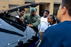 People gather around the hood of a helicopter