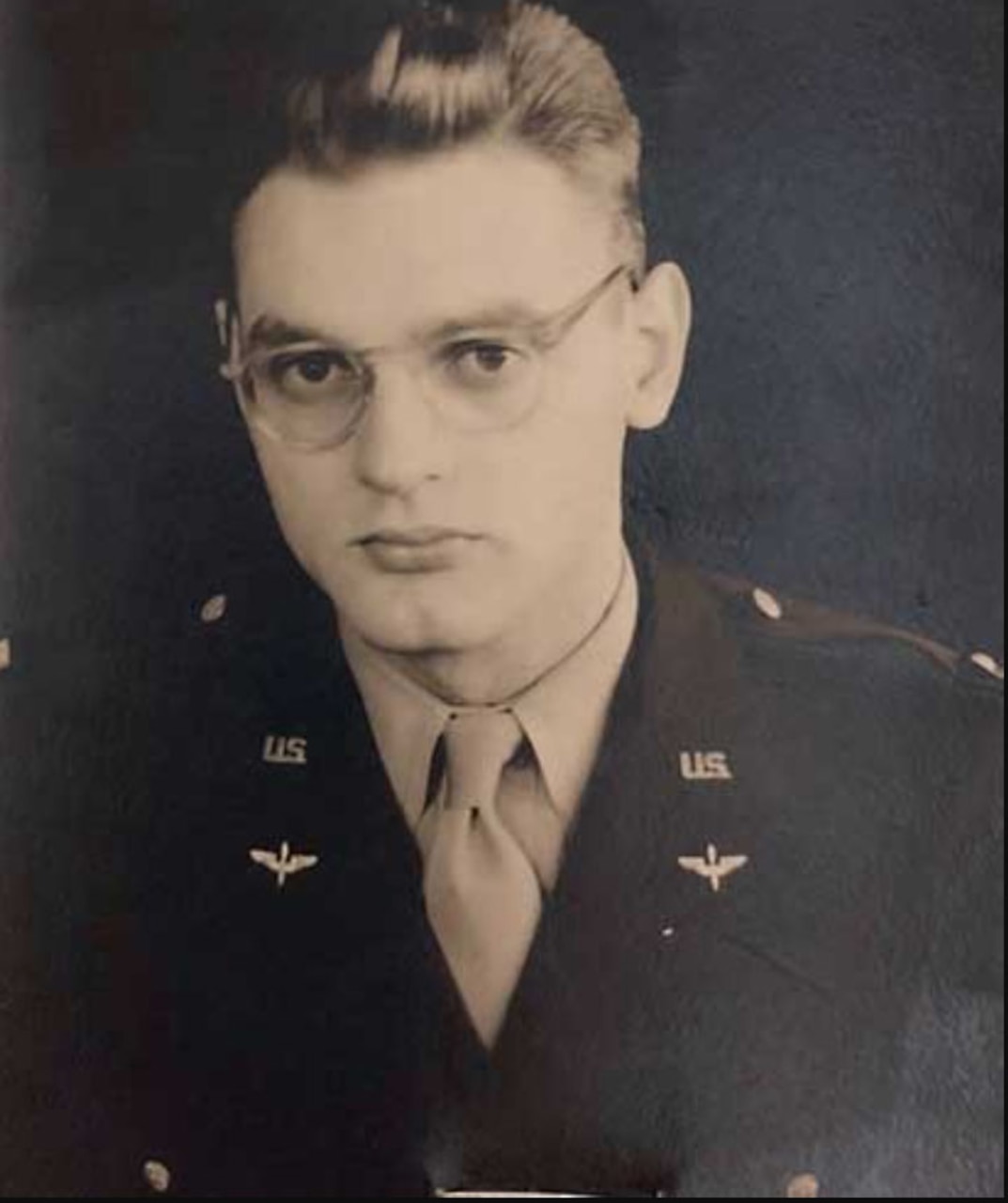 A soldier in uniform poses for a photo.