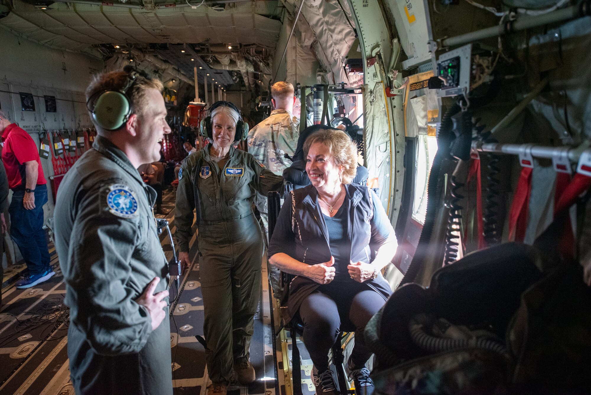 U.S. Air Force Senior Airman Keaton Fenwick, left, a loadmaster with the Kentucky Air National Guard’s 165th Airlift Squadron, talks with Jo-Ann Farmer, Jefferson County coroner, right, during an orientation flight over northern Kentucky aboard a C-130J Super Hercules aircraft Sept. 19, 2024. The flight was part of an Employer Support of the Guard and Reserve Bosslift, a community outreach program designed to enhance understanding of the Guard mission among civilian employers. (U.S. Air National Guard photo by Phil Speck)