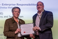Caral E. Spangler, Assistant Secretary of the Army for Financial Management and Comptroller, presents Domenico “Doc” Rossi, Office of the ASA (FM&C) Management and Control chief, with a certificate of appreciation during the Army’s Annual Audit Summit at the Mark Center in Alexandria, Virginia, Dec. 10, 2024. Rossi’s and his team’s efforts helped the Army close out the Entity Level Controls – Enterprise Responsivities General Fund and Working Capital Fund material weaknesses in Fiscal Year 2024. (U.S. Army photo by Mark R. W. Orders-Woempner)