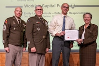 Caral E. Spangler, Assistant Secretary of the Army for Financial Management and Comptroller, along with Lt. Gen. Paul A. Chamberlain, Military Deputy to the ASA (FM&C), and Sgt. Maj. Terry L. Anderson, ASA (FM&C) senior enlisted advisor, present Jared Terry, U.S. Army Materiel Command Resource Management (G-8) deputy director, with a certificate of appreciation during the Army’s Annual Audit Summit at the Mark Center in Alexandria, Virginia, Dec. 10, 2024. Terry’s and his team’s efforts helped the Army downgrade a Working Capital Fund material weakness in Fiscal Year 2024. (U.S. Army photo by Mark R. W. Orders-Woempner)