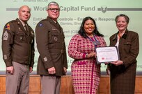 Caral E. Spangler, Assistant Secretary of the Army for Financial Management and Comptroller, along with Lt. Gen. Paul A. Chamberlain, Military Deputy to the ASA (FM&C), and Sgt. Maj. Terry L. Anderson, ASA (FM&C) senior enlisted advisor, present Tanya Gilliam, U.S. Army Materiel Command audit readiness specialist, with a certificate of appreciation during the Army’s Annual Audit Summit at the Mark Center in Alexandria, Virginia, Dec. 10, 2024. Gilliam’s and her team’s efforts helped the Army downgrade a Working Capital Fund material weakness in Fiscal Year 2024. (U.S. Army photo by Mark R. W. Orders-Woempner)