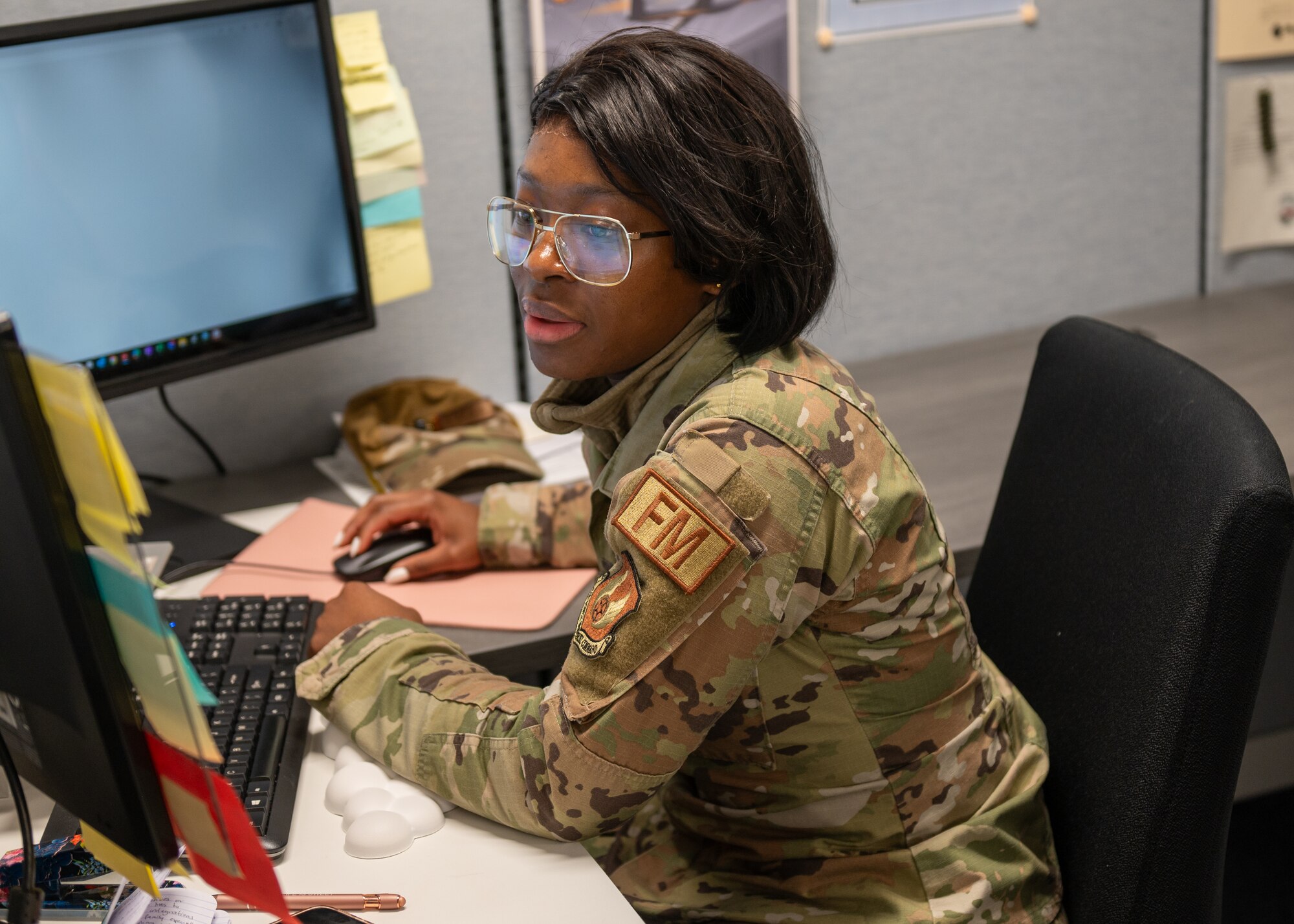 An Airman sits at her computer.