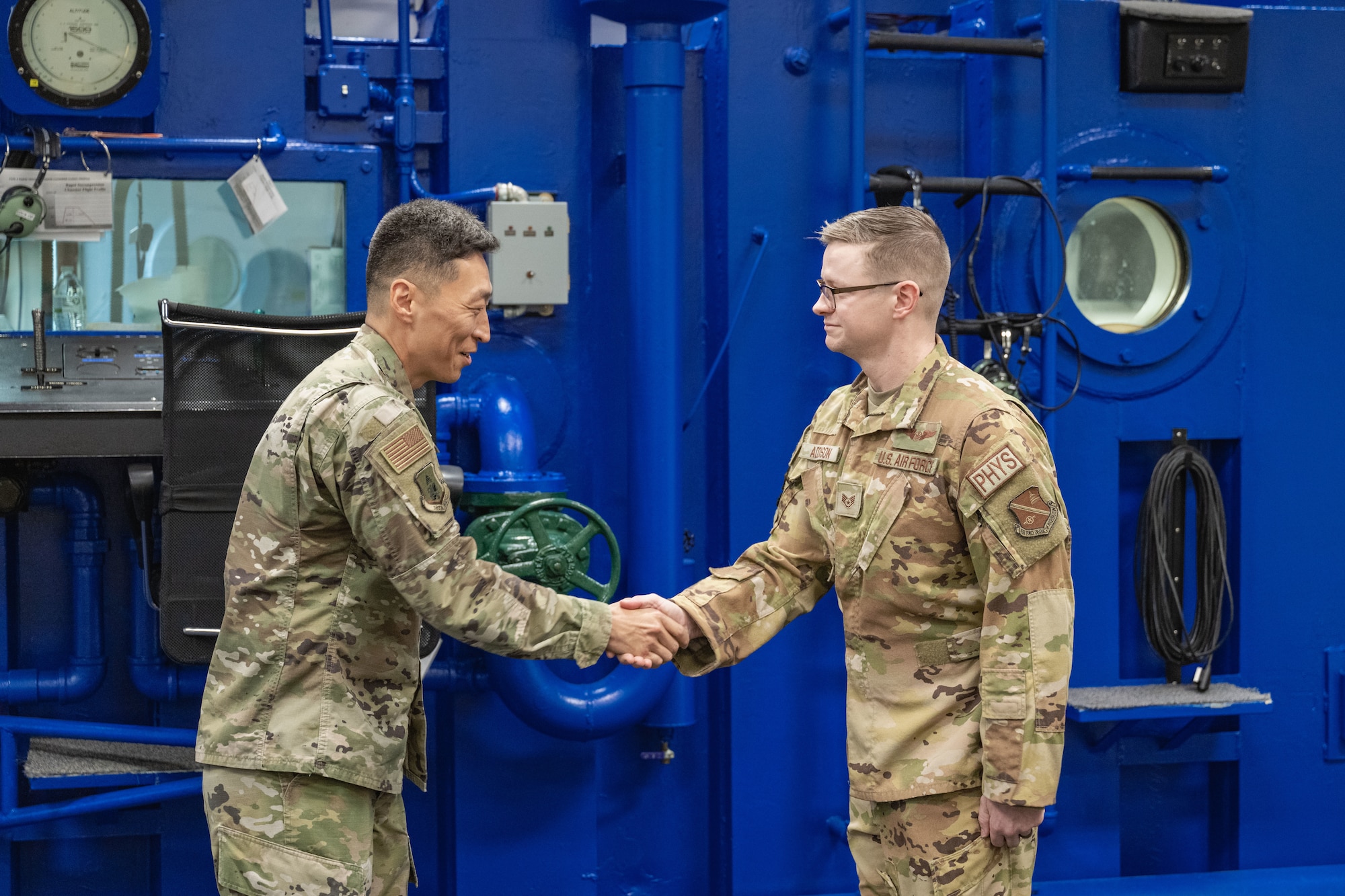 Col. Jun S. Oh presents Staff Sgt. Jordan Addison with a coin for Winnin' like a Griffin.
