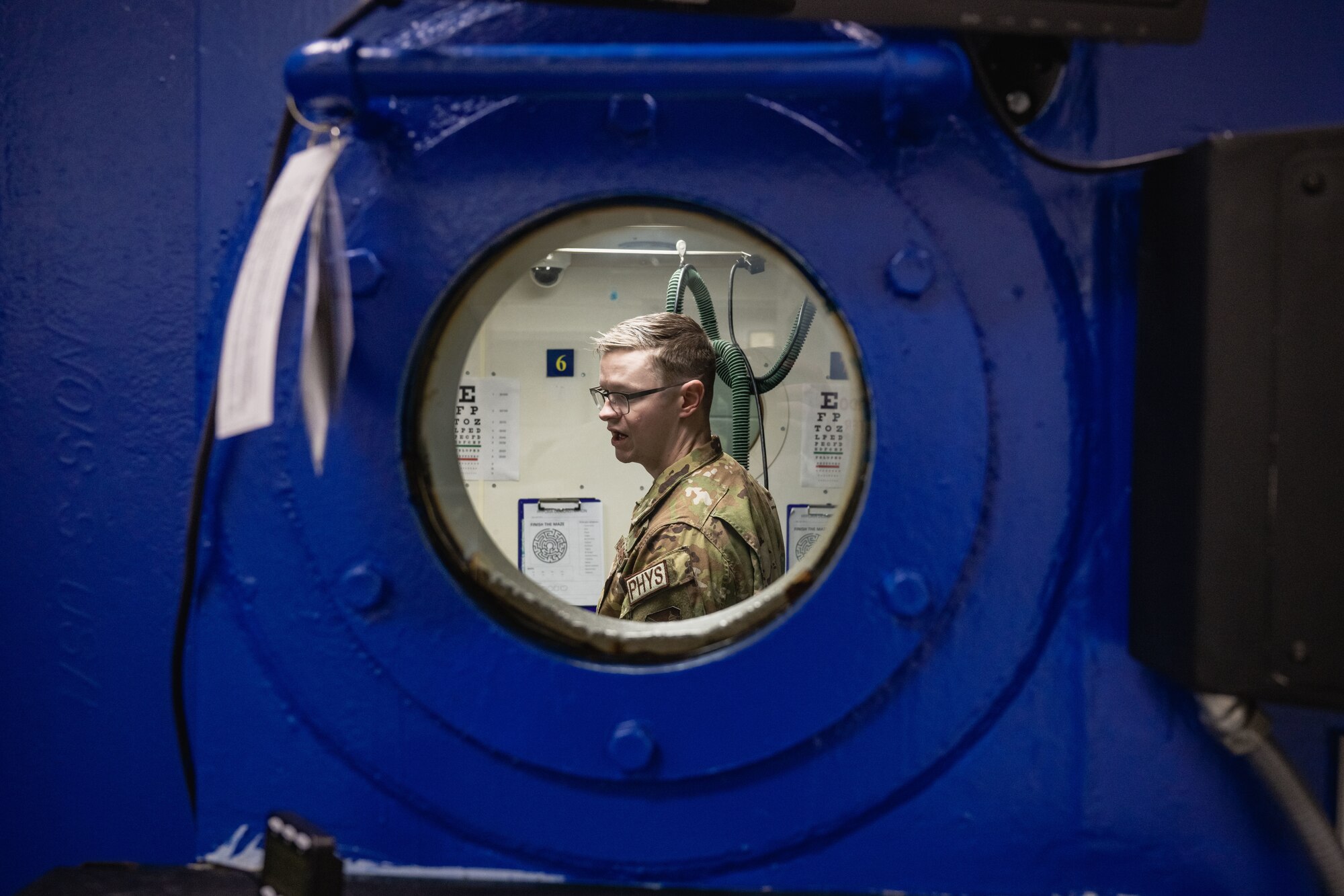Staff Sgt. Jordan Addison guides a tour of the altitude chamber.