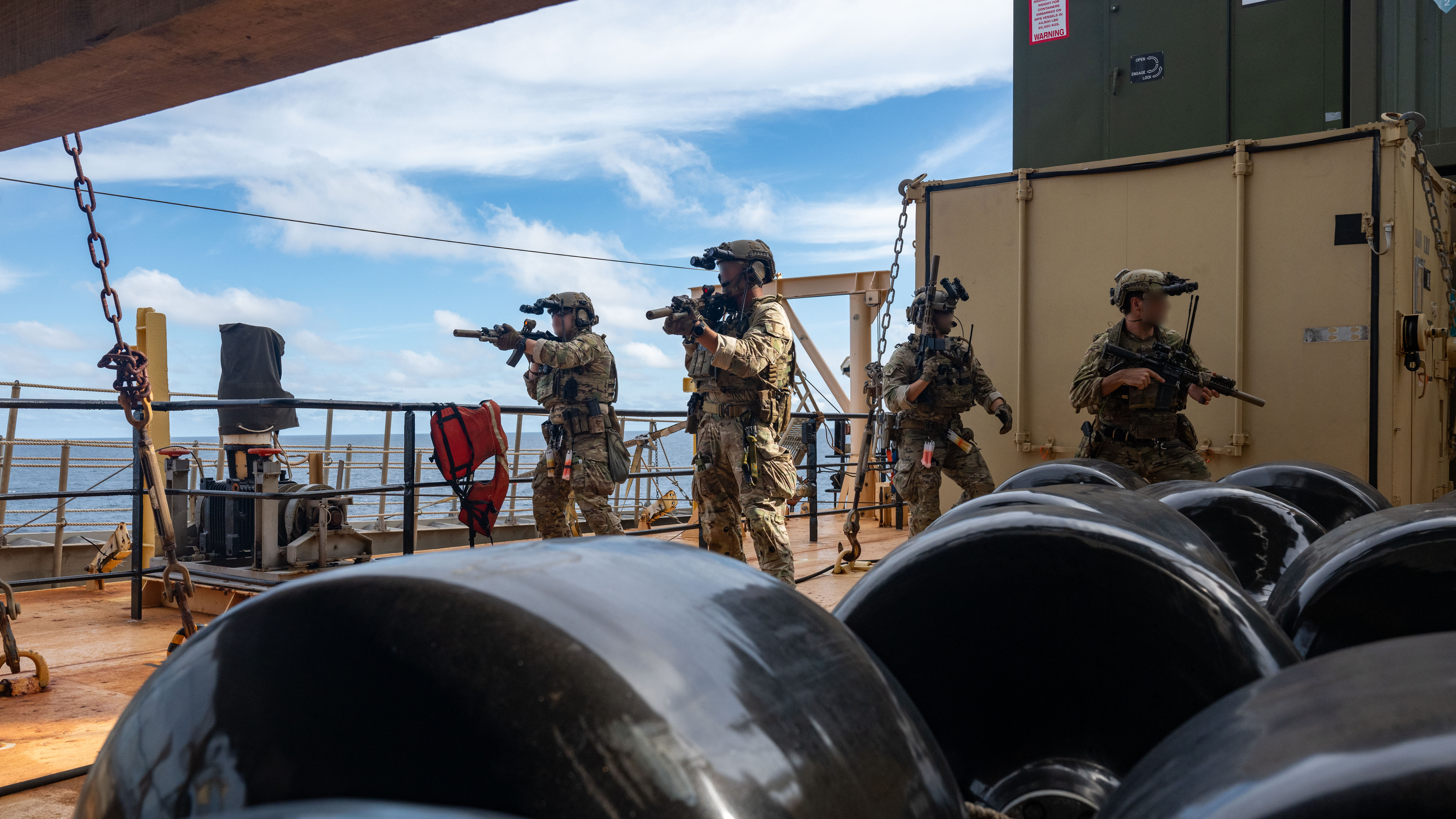 U.S. Naval Special Warfare operators and U.S. Coast Guard Maritime Security Response Team (West) members conduct visit, board, search, and seizure training aboard the 2nd Lt. John P. Bobo-class cargo ship USNS PFC Dewayne T. Williams (T-AK 3009) in the Andaman Sea, Dec. 16, 2024.