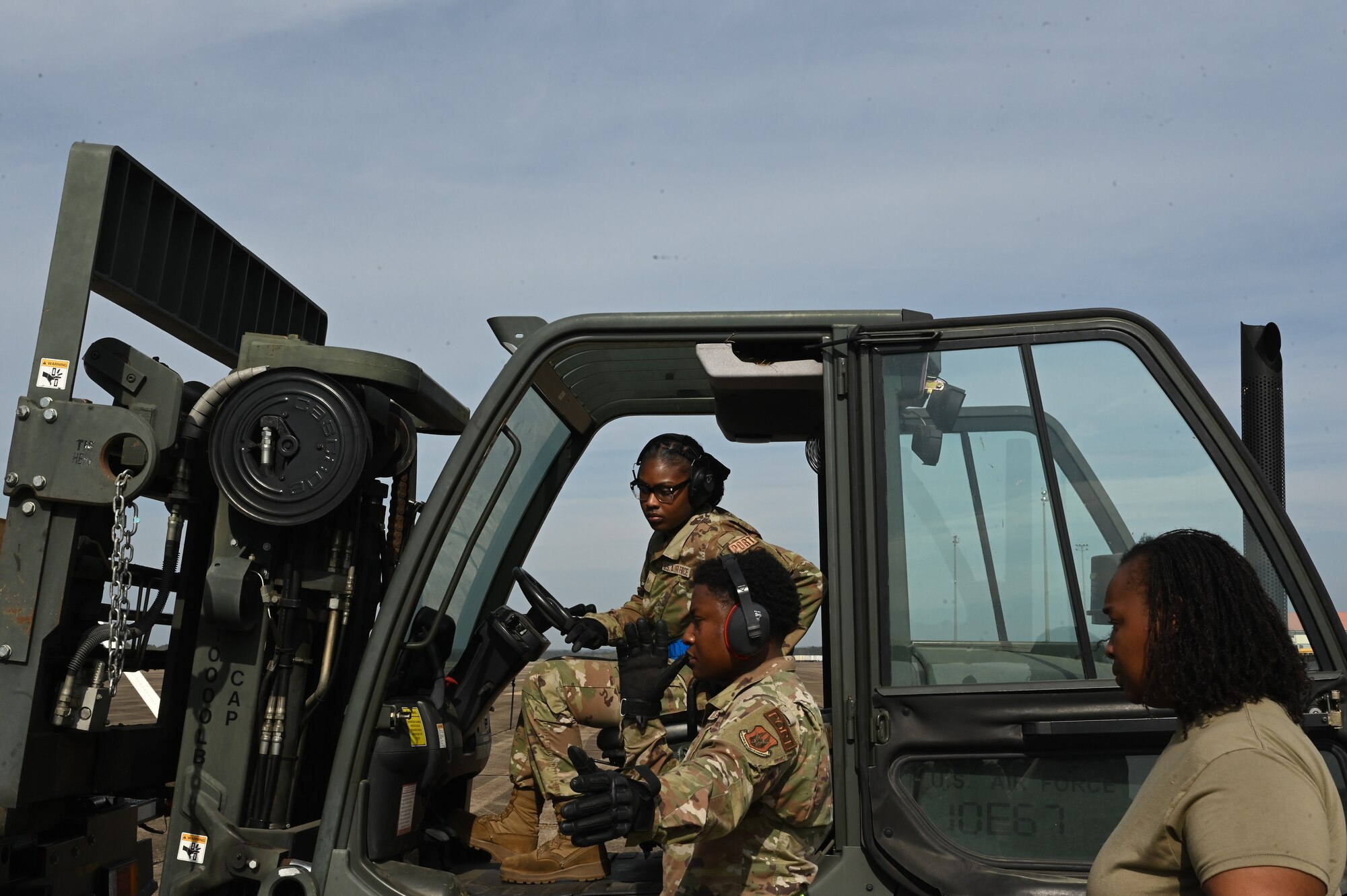 people prepare to load cargo onto an aircraft