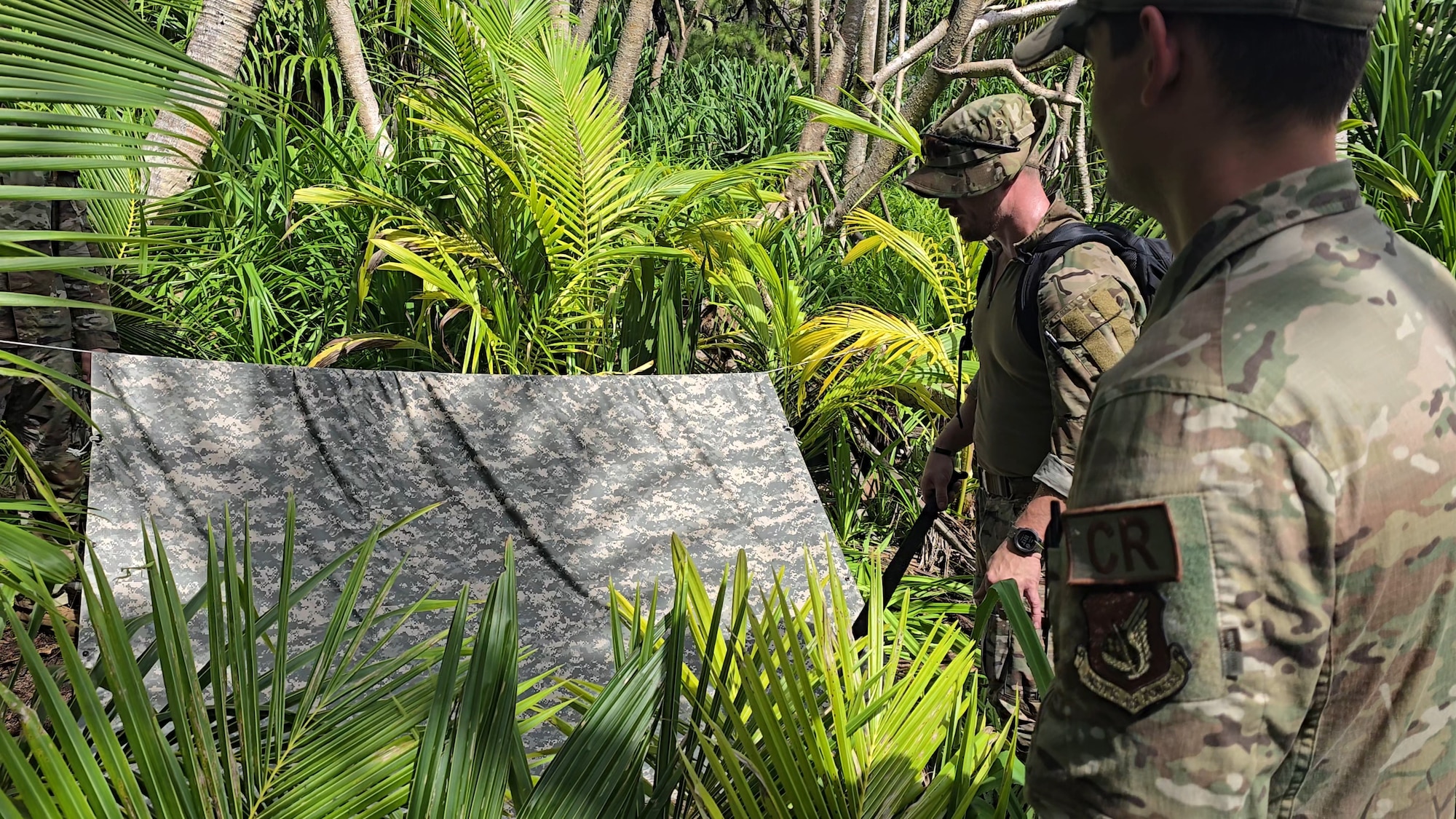 148th Fighter Wing Security Forces specialist, Master Sgt. Ian Nickila (left) builds a hasty shelter on Oct. 10, 2024, as part of the Air Force's Jungle Agile Combat Employment Course at Anderson Air Force Base, Guam. (U.S. Air Force photo by Tech. Sgt. Stephen Tamashiro)