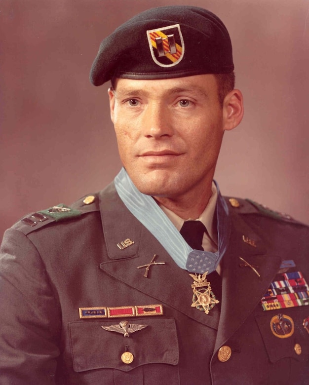 A man in a uniform poses for a photo.