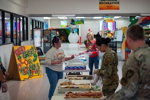 Civilians and military members package cookies