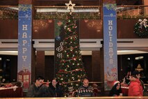 U.S. Soldiers, civilians, distinguished guests, and family members gather to celebrate the holiday season during an annual tree lighting ceremony at the Dragon Hill Lodge, Yongsan, South Korea, Dec. 17, 2024.