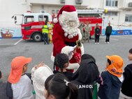 U.S. Army Garrison Okinawa’s Santa Claus greets local children from Takenoko and Pono-Pono daycare centers during a Holiday celebration in Yomitan Village, Okinawa, Japan, on Dec. 19, 2024.