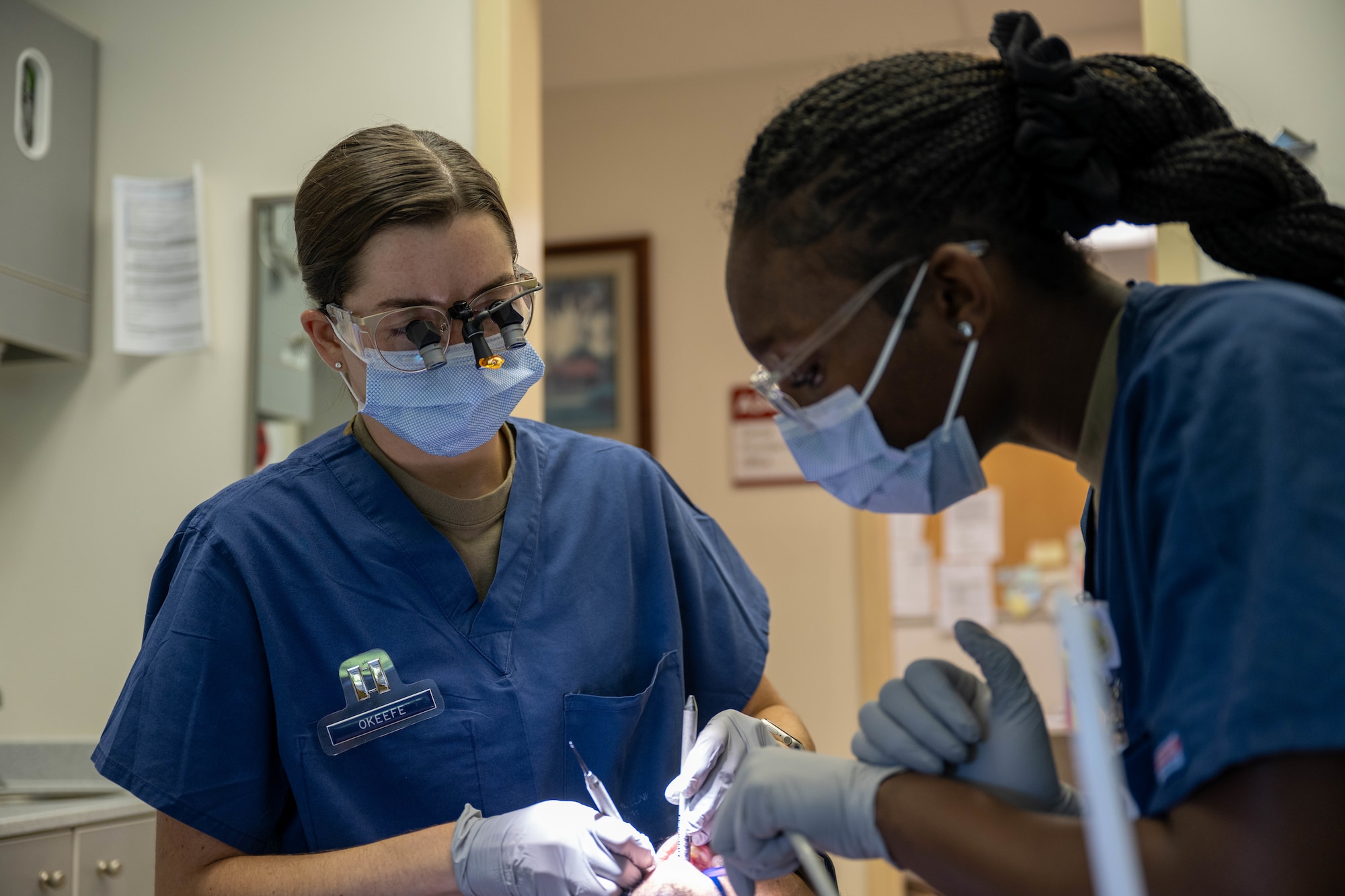 A dentist and dental assistant work on a patients teeth on Joint Base Pearl Harbor-Hickam, Hawaii.