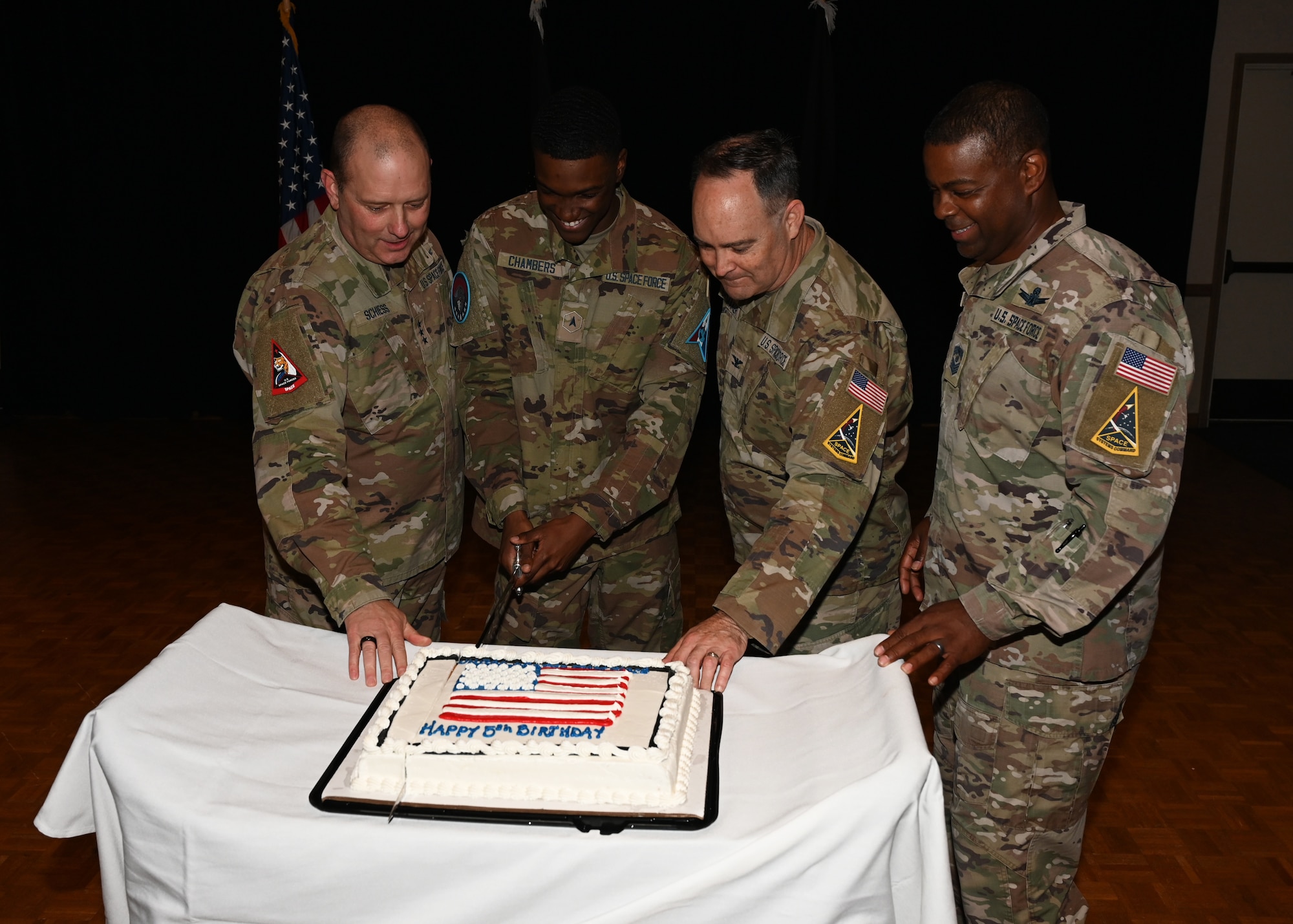 People cutting into a cake.