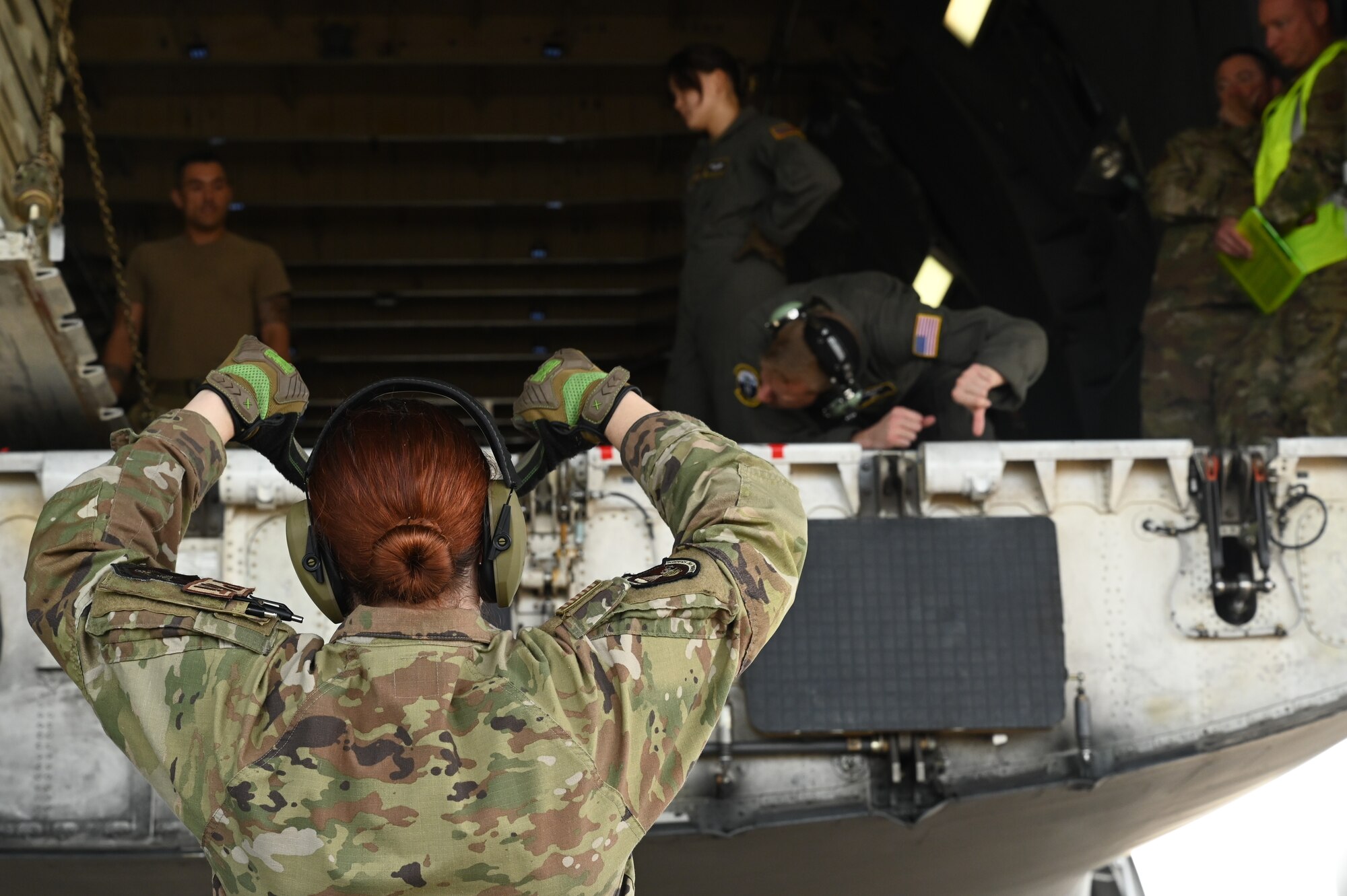 people load cargo onto an aircraft