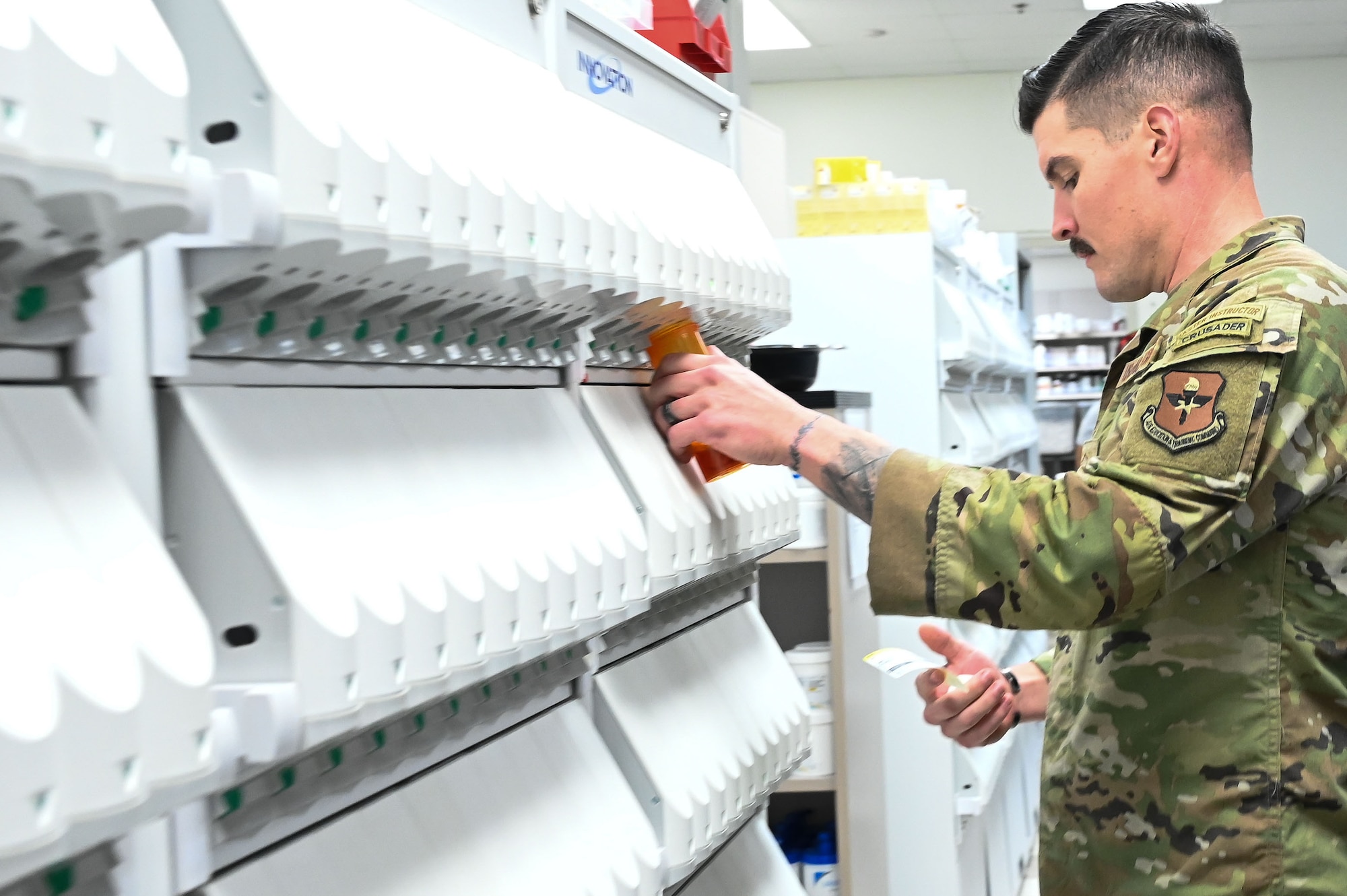 U.S. Air Force Master Sgt. Robert Tatum, 42nd Medical Group pharmacy flight chief, pulls medicine to fill a prescription at the pharmacy on Maxwell Air Force Base, Alabama, Dec. 16, 2024.