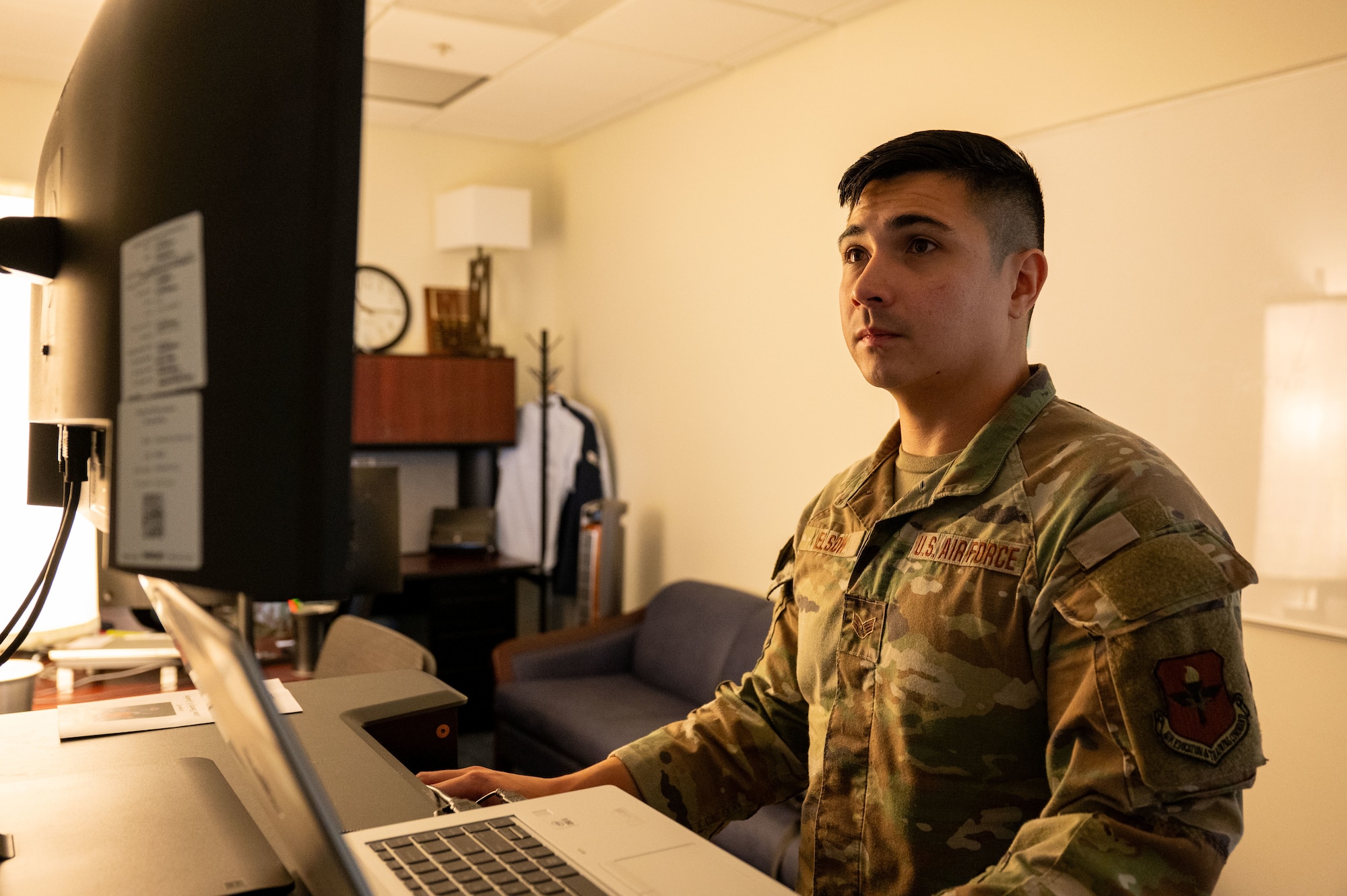 U.S. Air Force Senior Airman Julian Elson, Air War College executive services admin, works at his desk at Maxwell Air Force Base, Alabama, Nov. 13, 2024. Initially assigned to the Maxwell Honor Guard, Elson demonstrated his selflessness by continuing to volunteer even after his rotation ended. This decision was motivated by his desire to support his team during a staffing shortage.